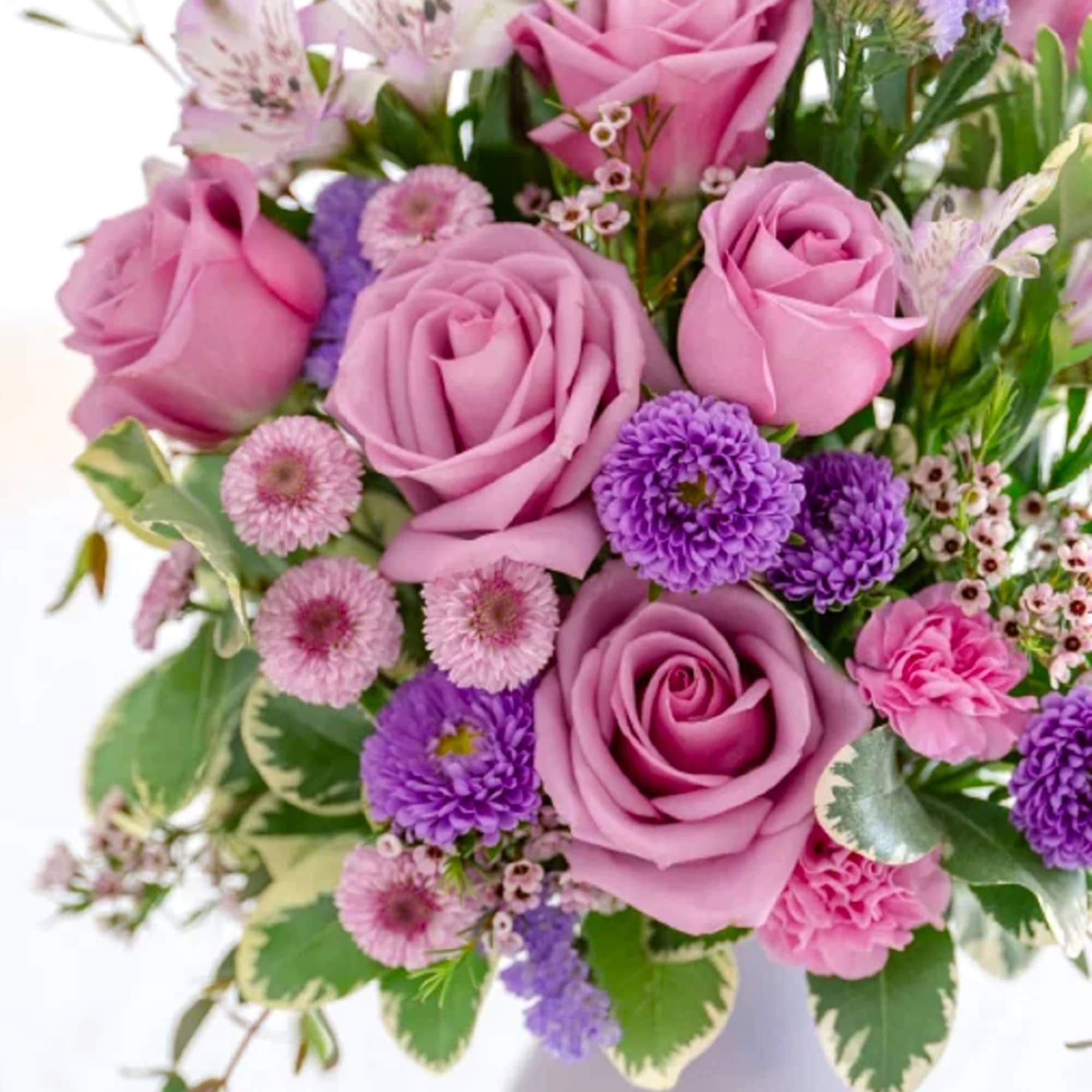 Pretty as a picture, this perfect purple arrangement spoils your someone special