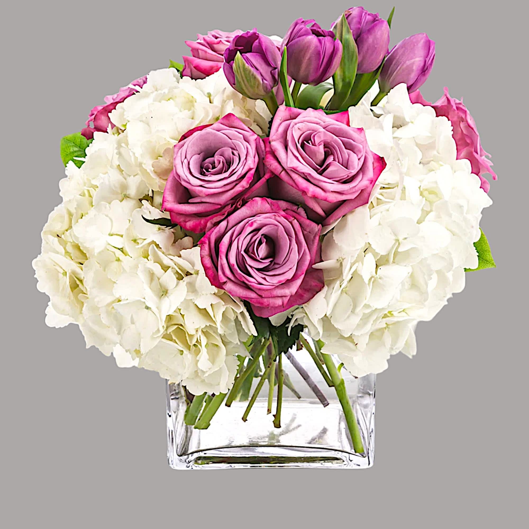Express your feelings with flowers. Sending this lovely purple and white arrangement