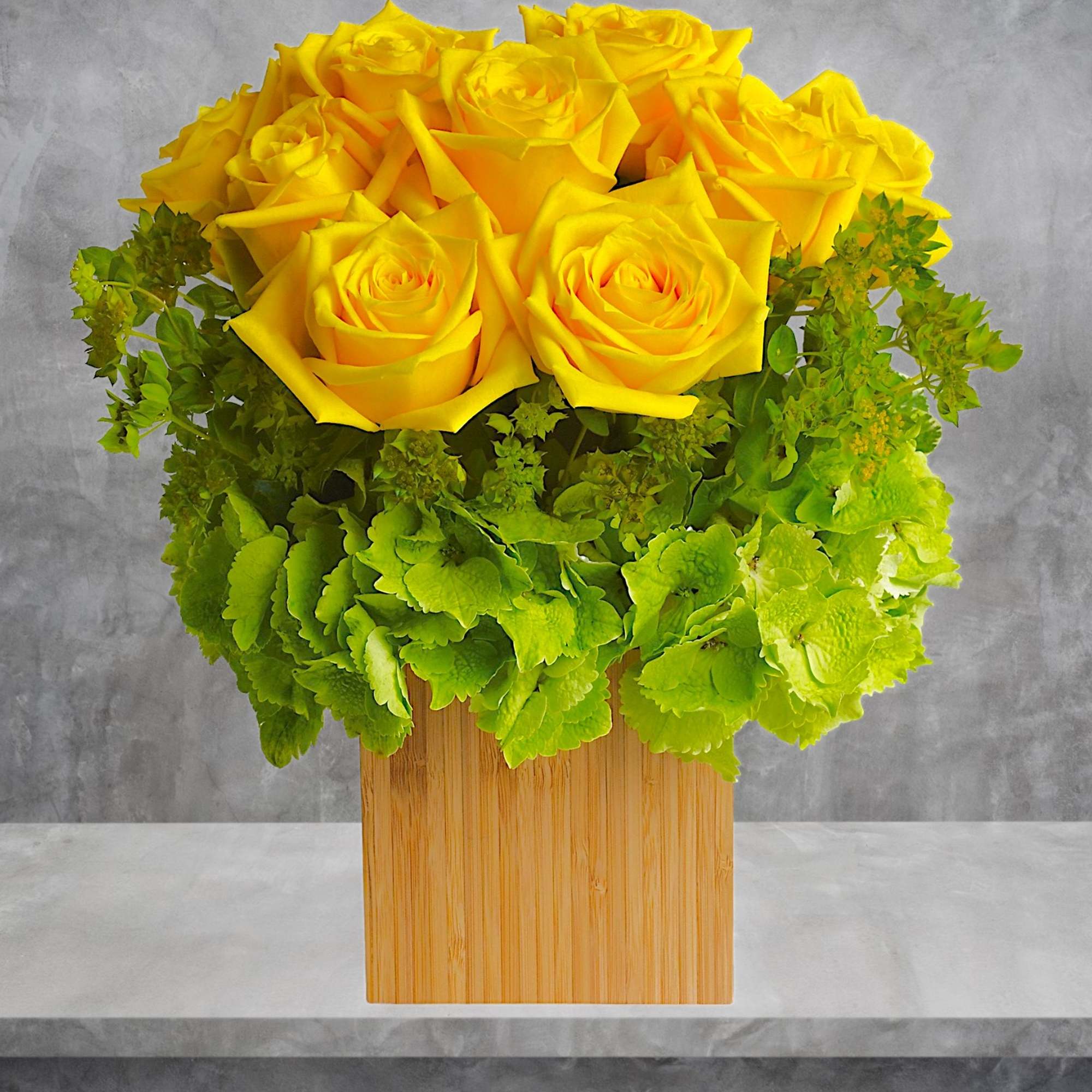 Sunny yellow roses go Zen! This modern rose arrangement features joyful yellow