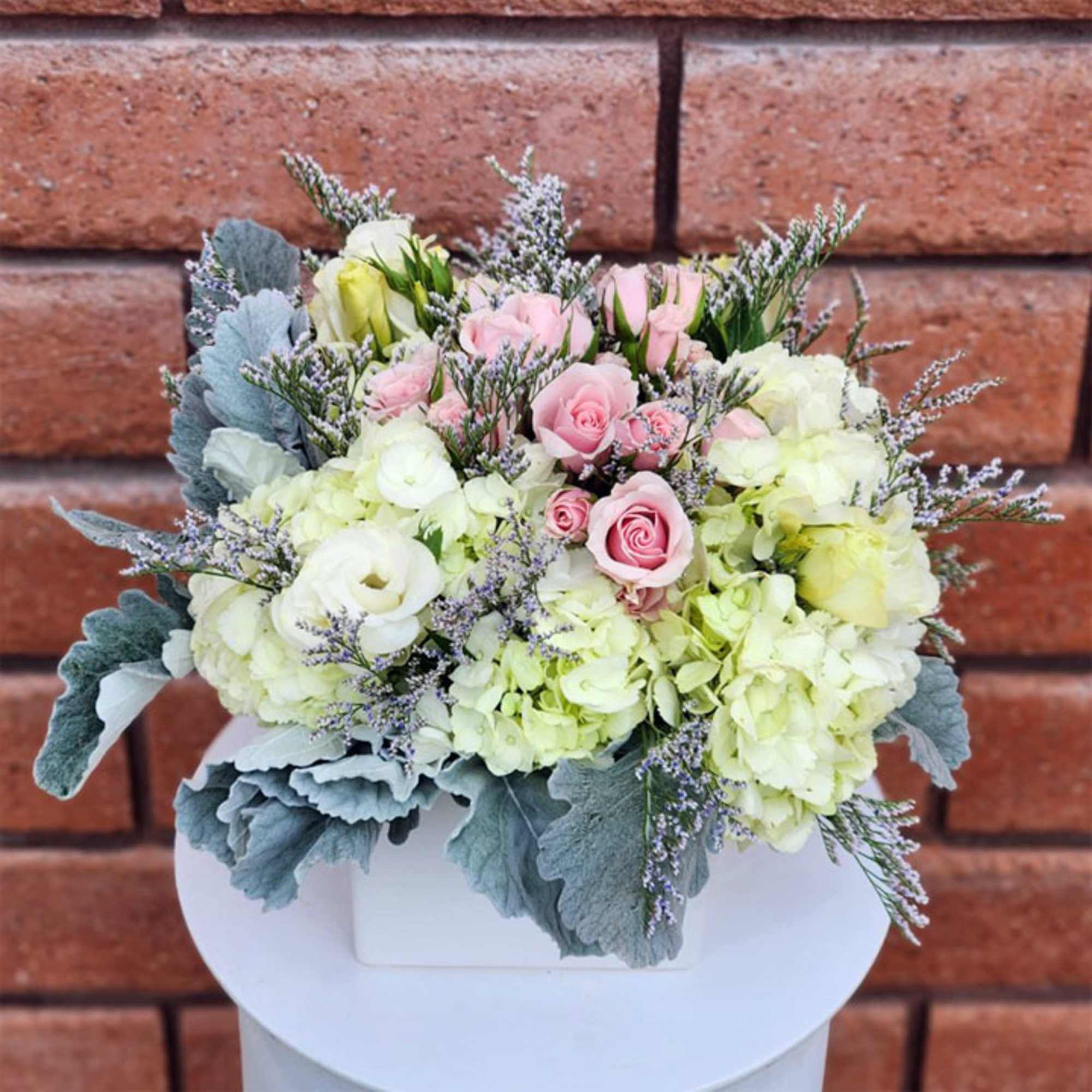 This angelic arrangement is as cute as it is pretty. Featuring the