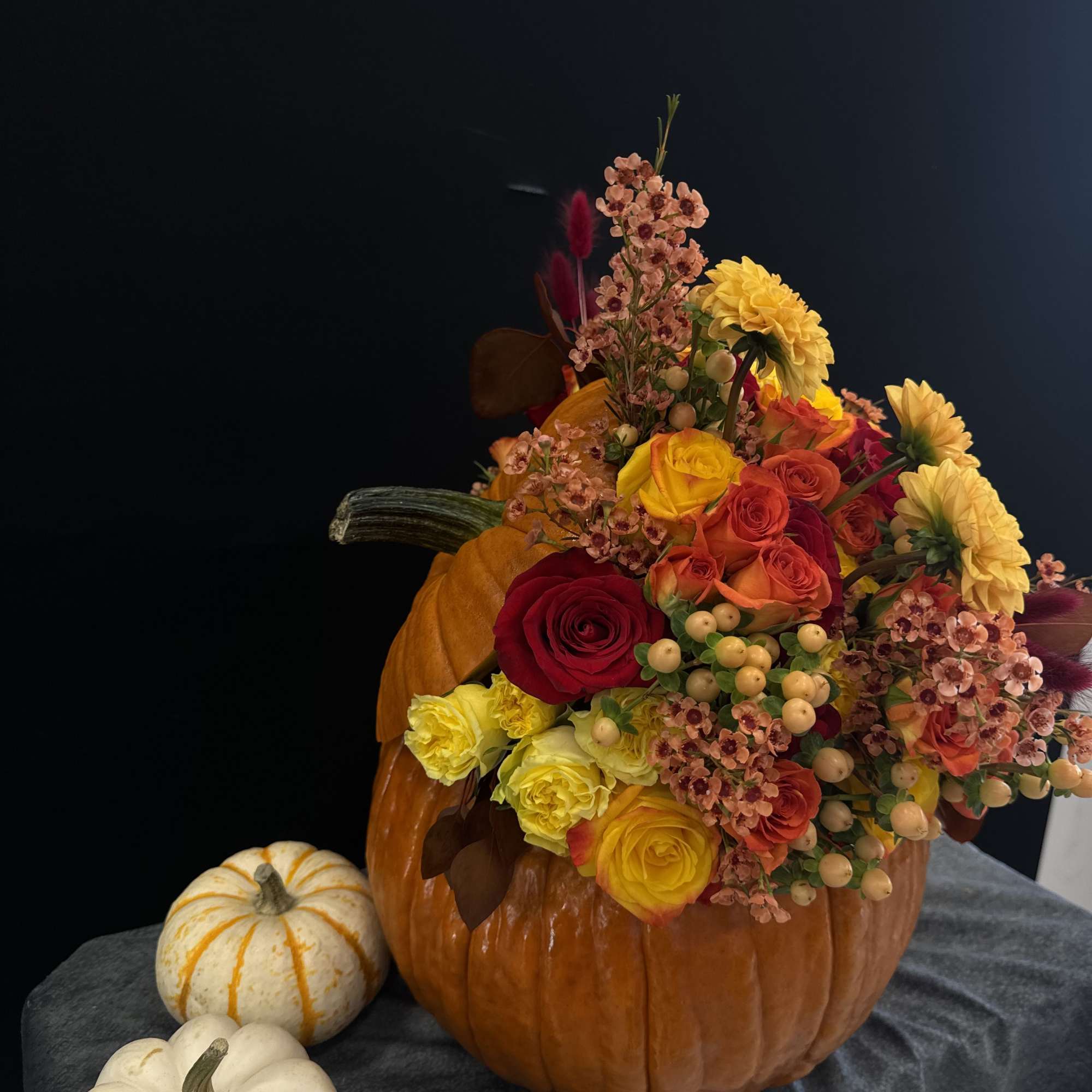 Beautiful autumn inspired arrangement in pumpkin 
