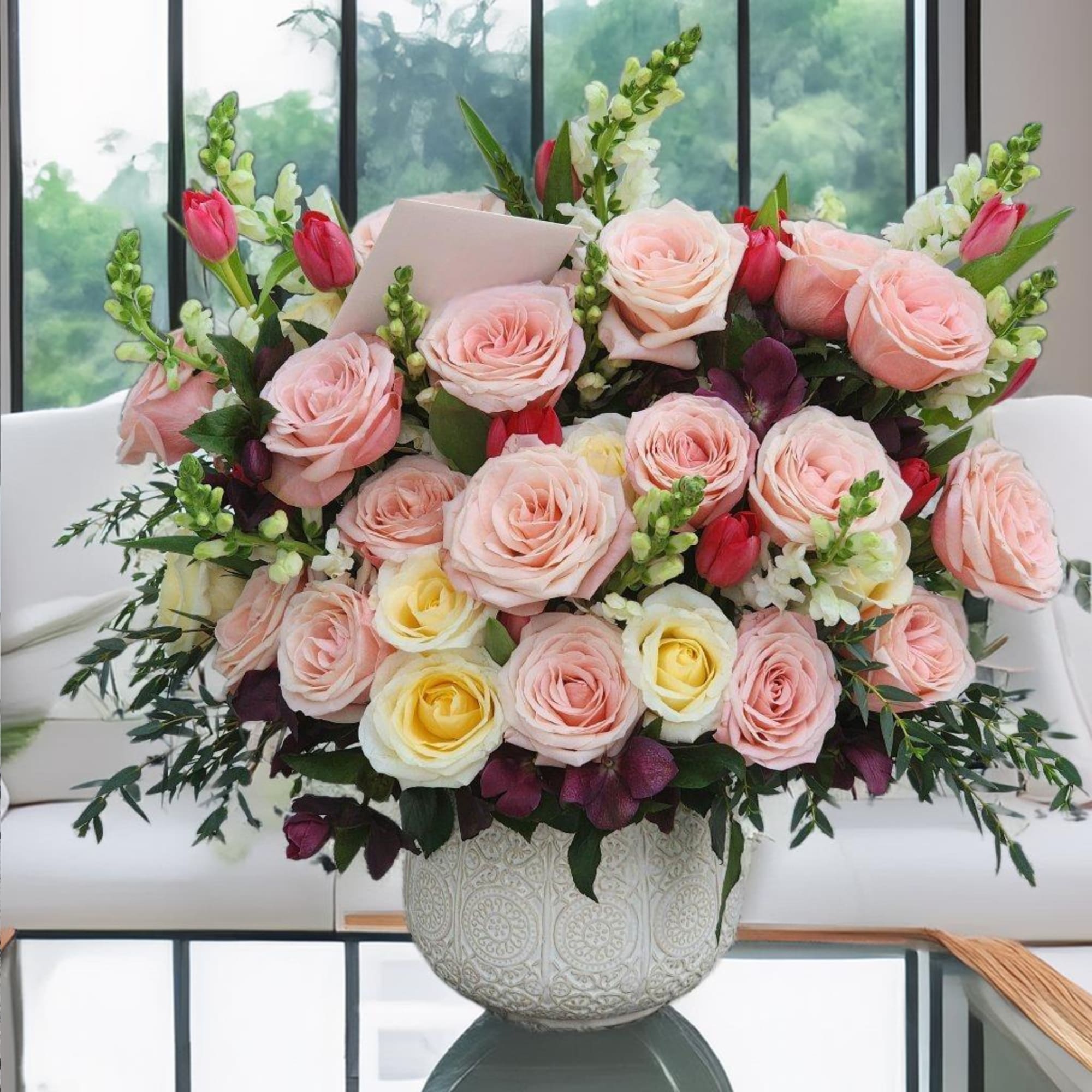 This stunning floral arrangement in a ceramic vase features of pink roses