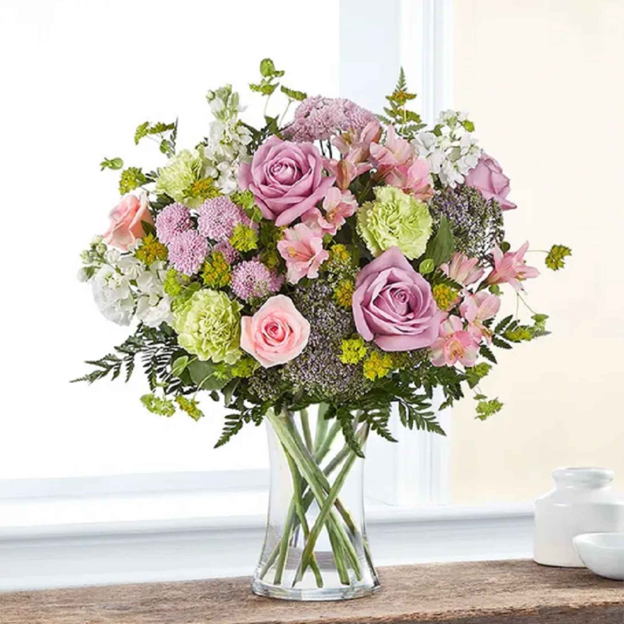 Celebrate any occasion with this charming garden floral arrangement! With a charm