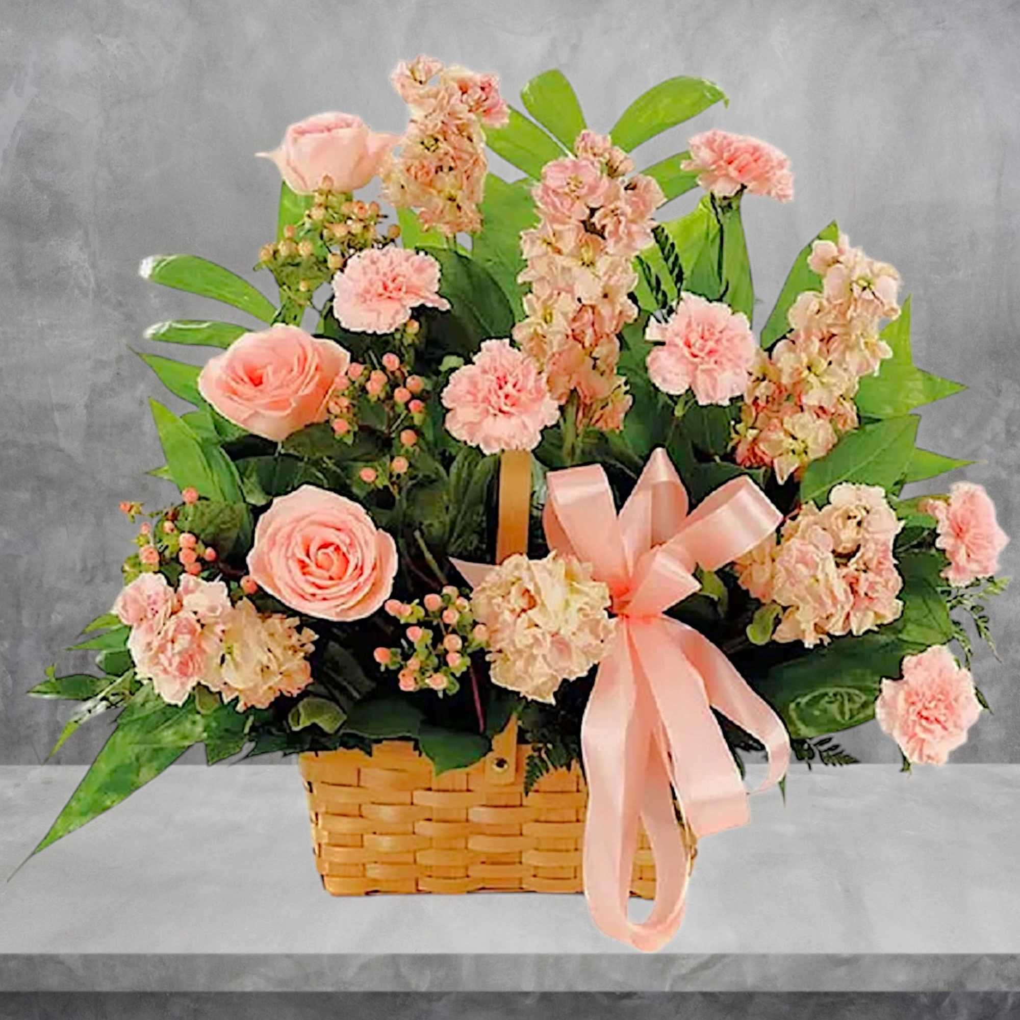 This classic peach fresh flower basket arrangement is a lovely way to
