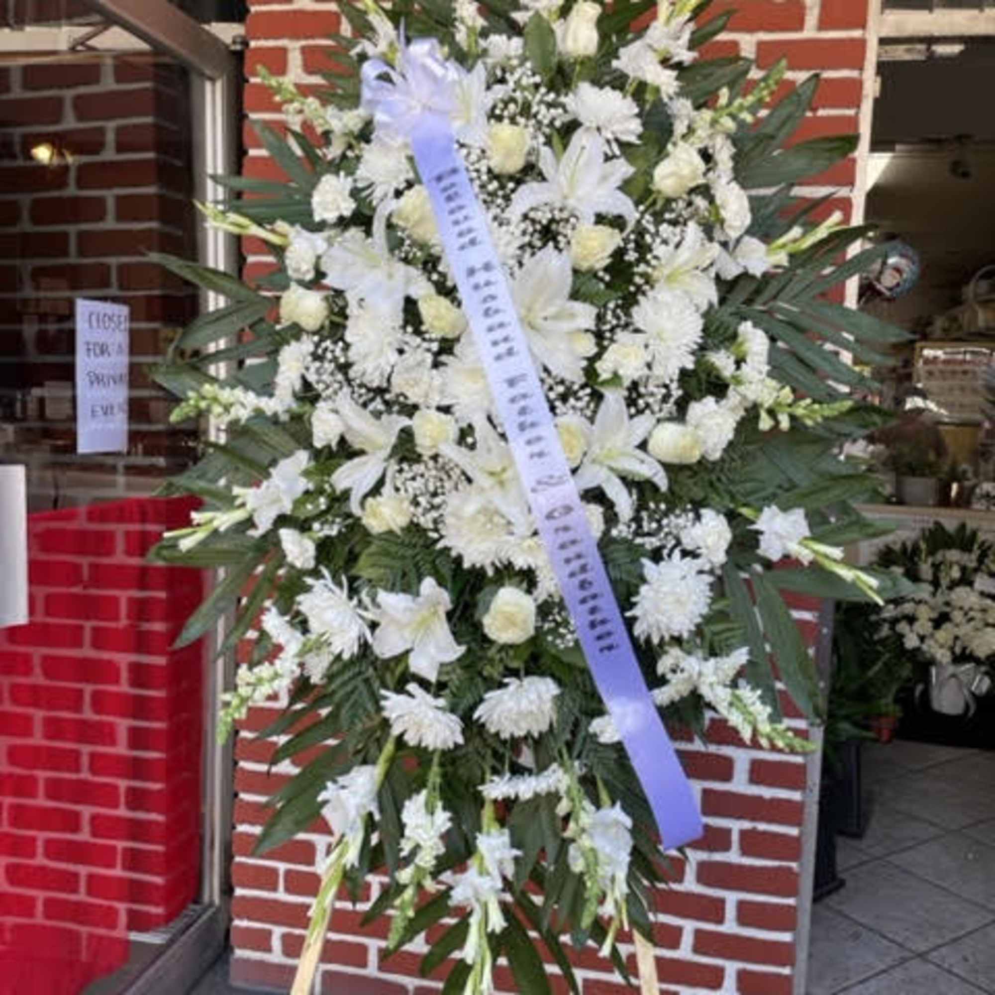 The Exquisite Tribute Standing Spray is an elegant display of sweet serenity. The Exquisite Tribute Standing Spray is an elegant display of sweet serenity.