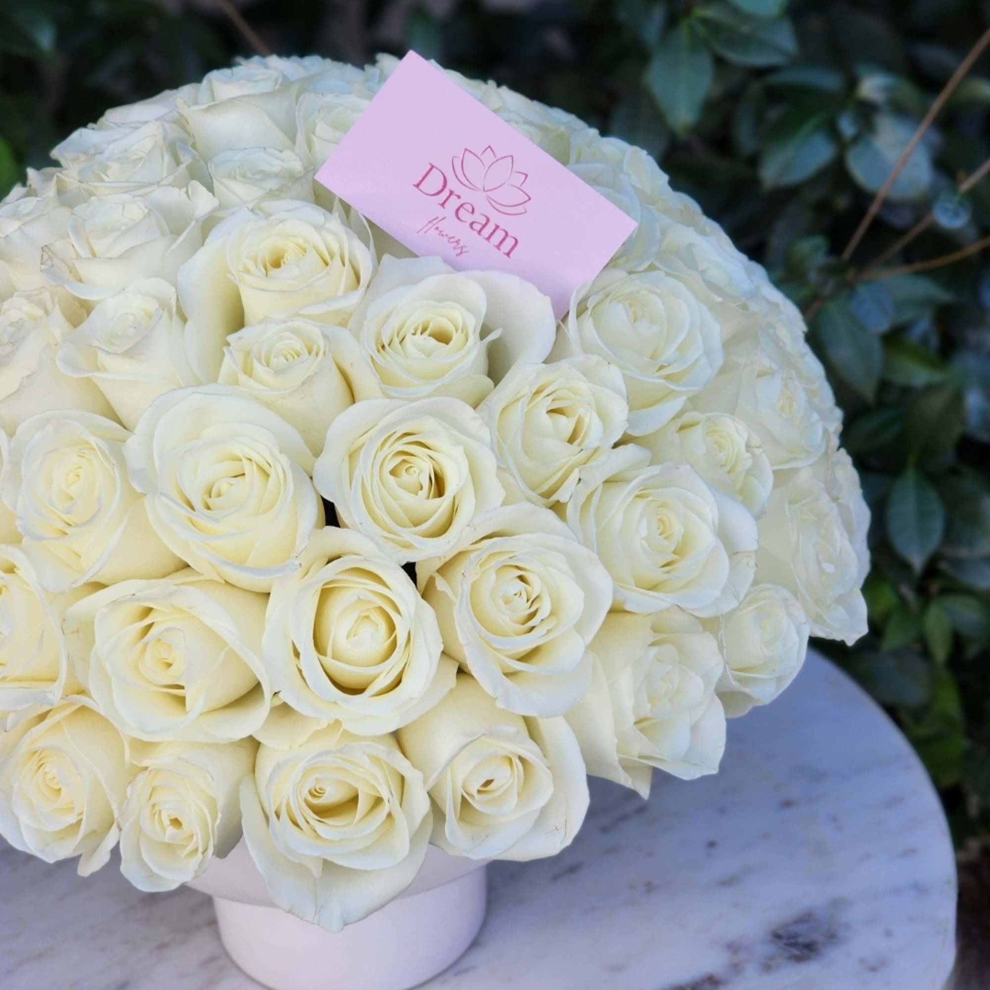 Pure elegance captured in a timeless arrangement: pristine white roses delicately cradled