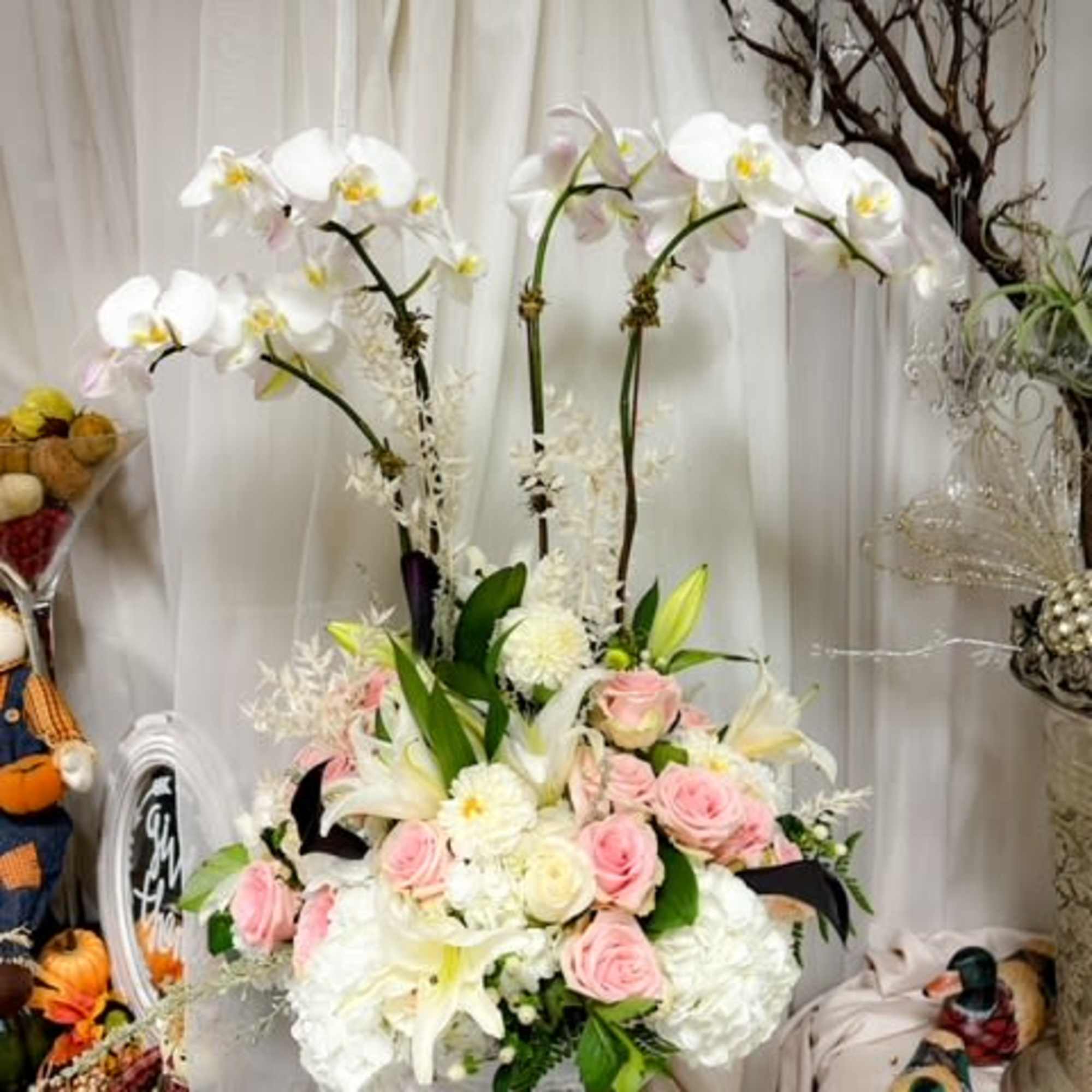 The Majestic Grace Arrangement is a stunning display of opulence and elegance