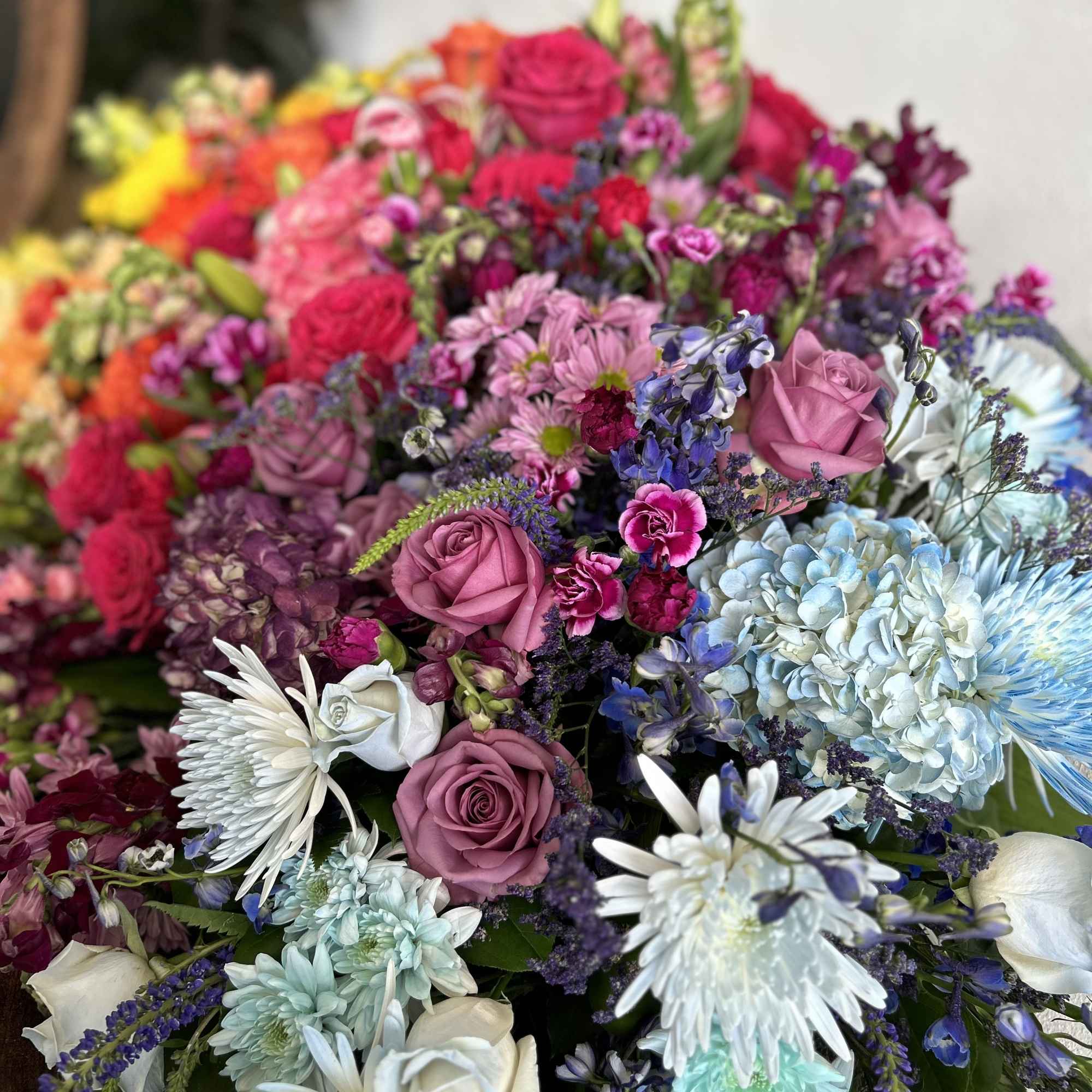 A beautiful multi colored casket blanket.