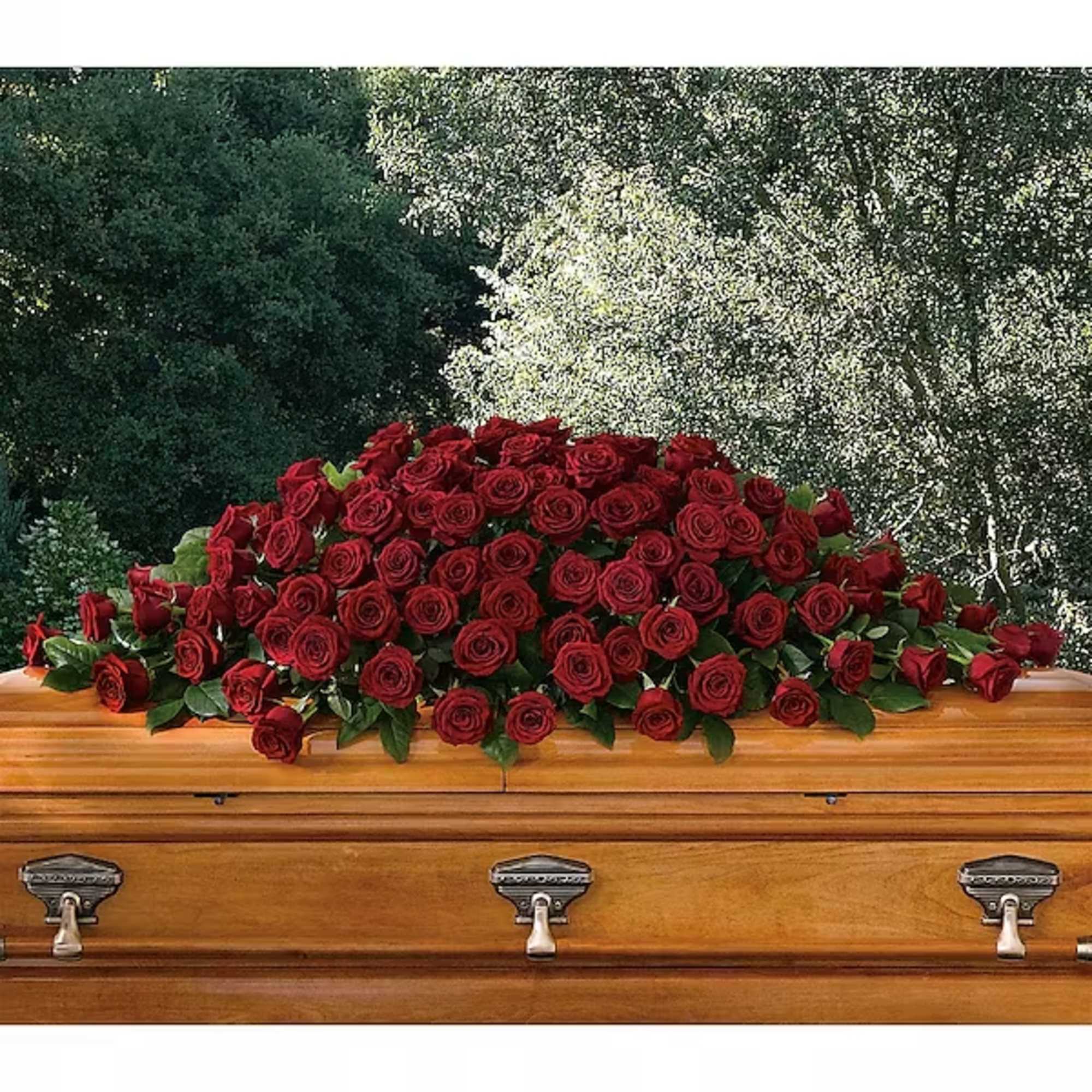 A loving embrace of rich, regal roses in an all-red spray to