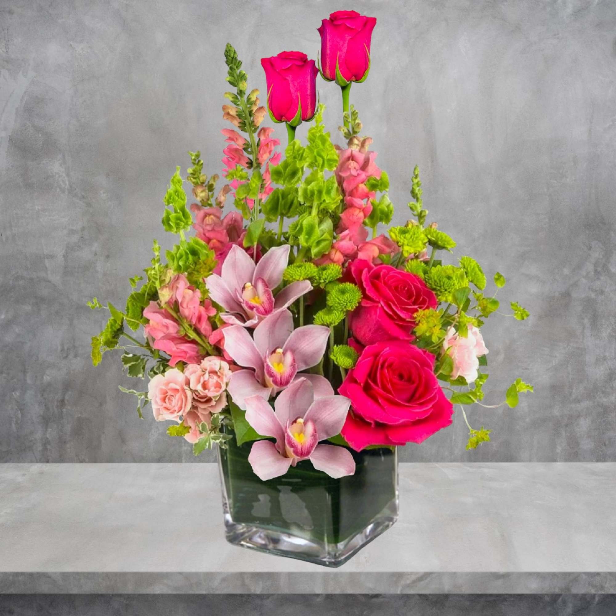 Escape to paradise with this lush and vibrant flower arrangement.  This