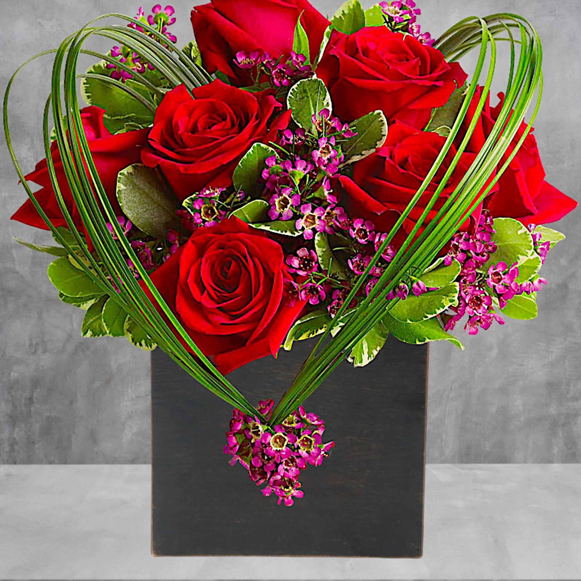 A graceful heart of bear grass... tied with purple waxflower blossoms... forms