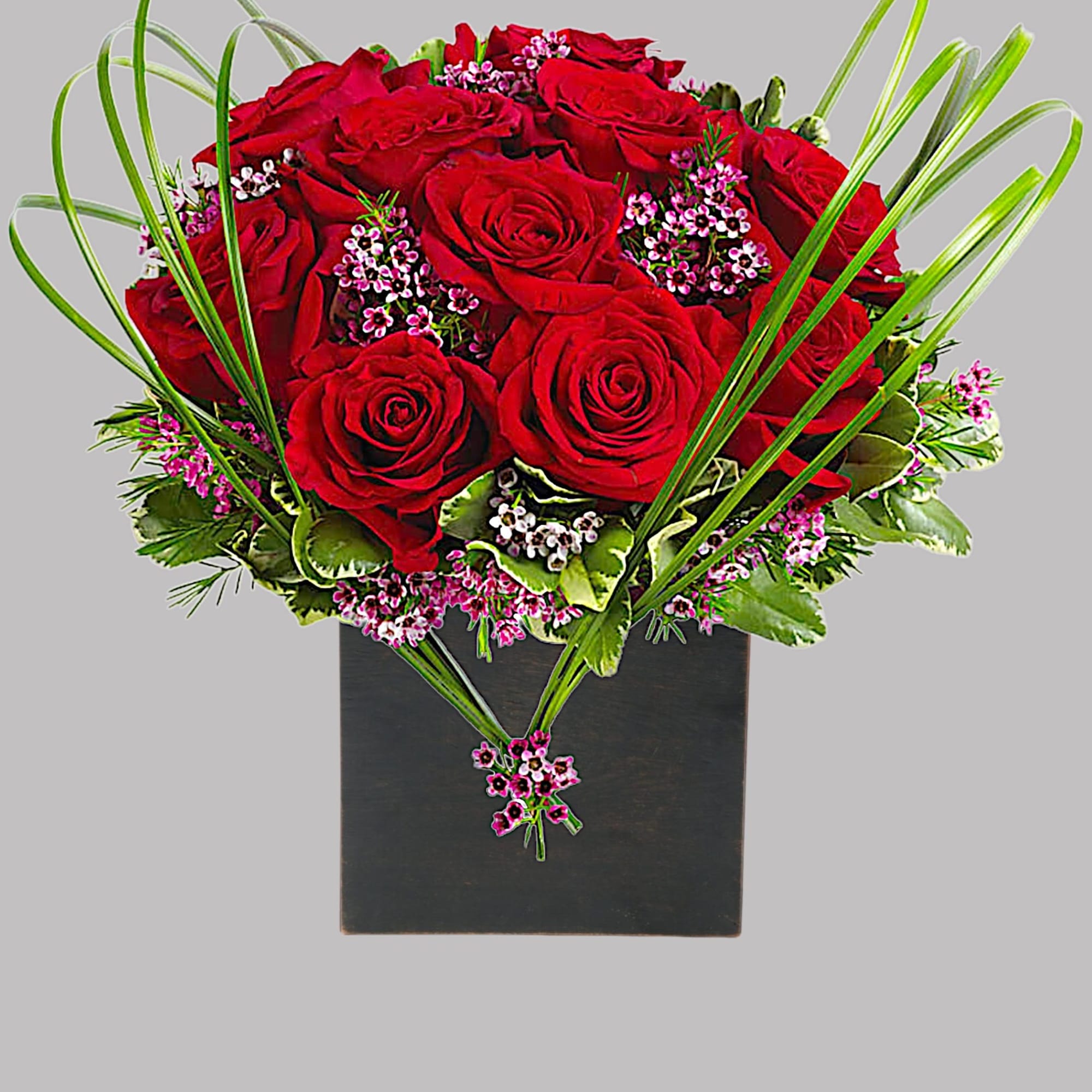 A graceful heart of bear grass... tied with purple waxflower blossoms... forms