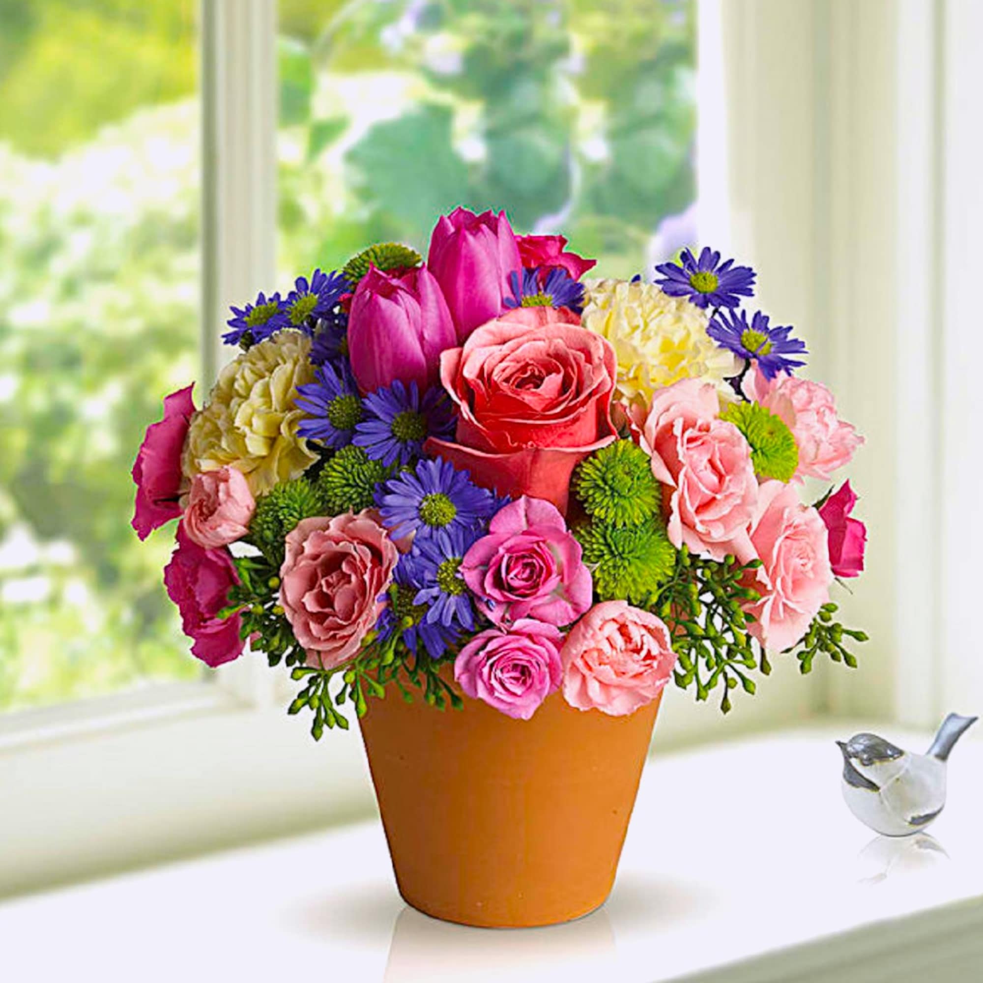 A warm terra-cotta pot and lots of fun colors give this arrangement