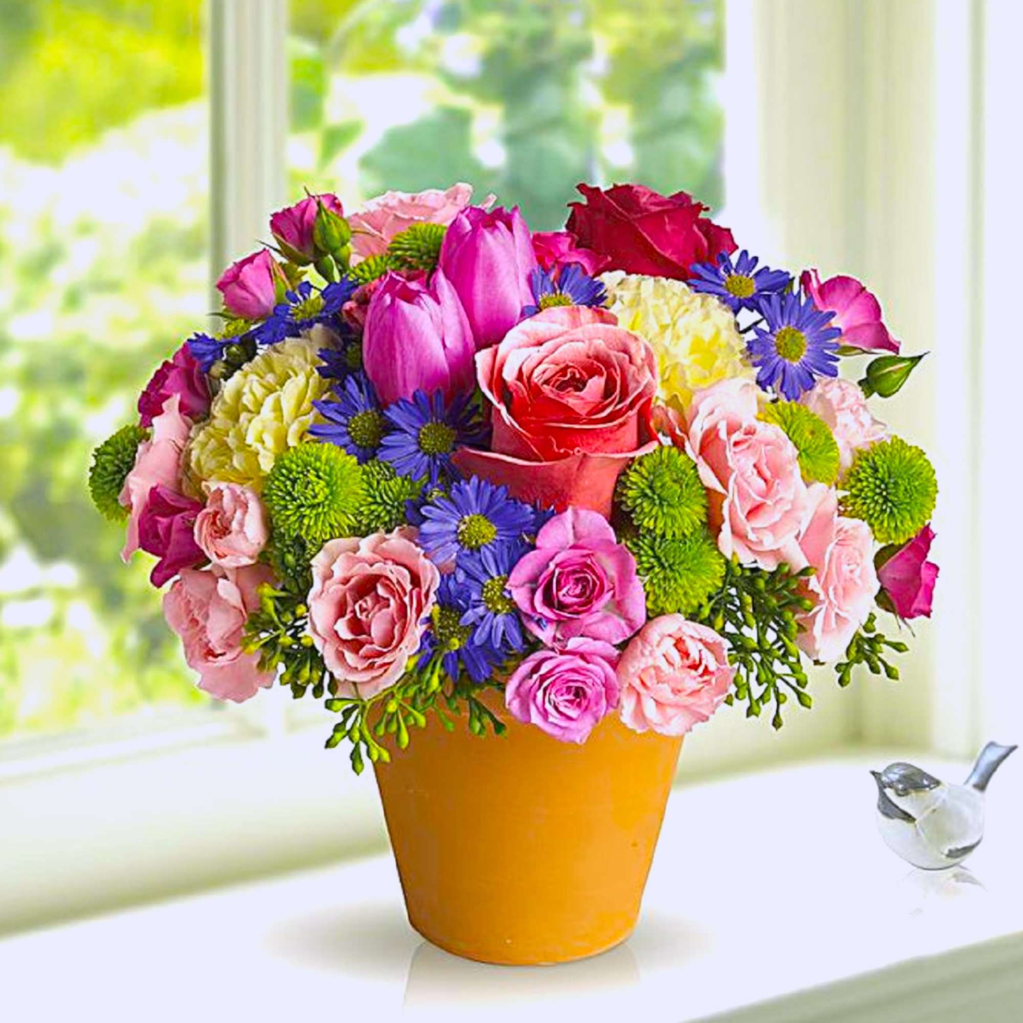 A warm terra-cotta pot and lots of fun colors give this arrangement