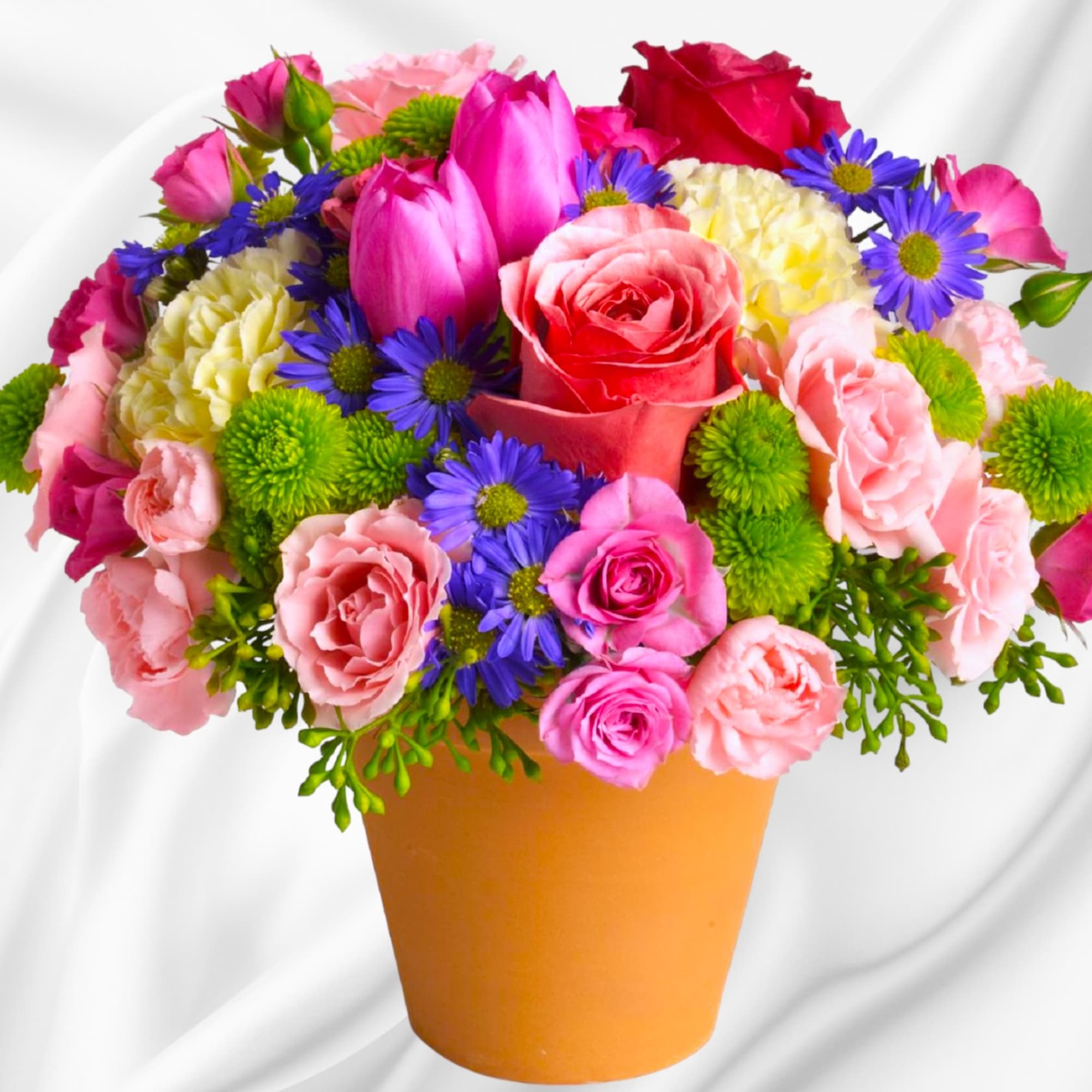 A warm terra-cotta pot and lots of fun colors give this arrangement