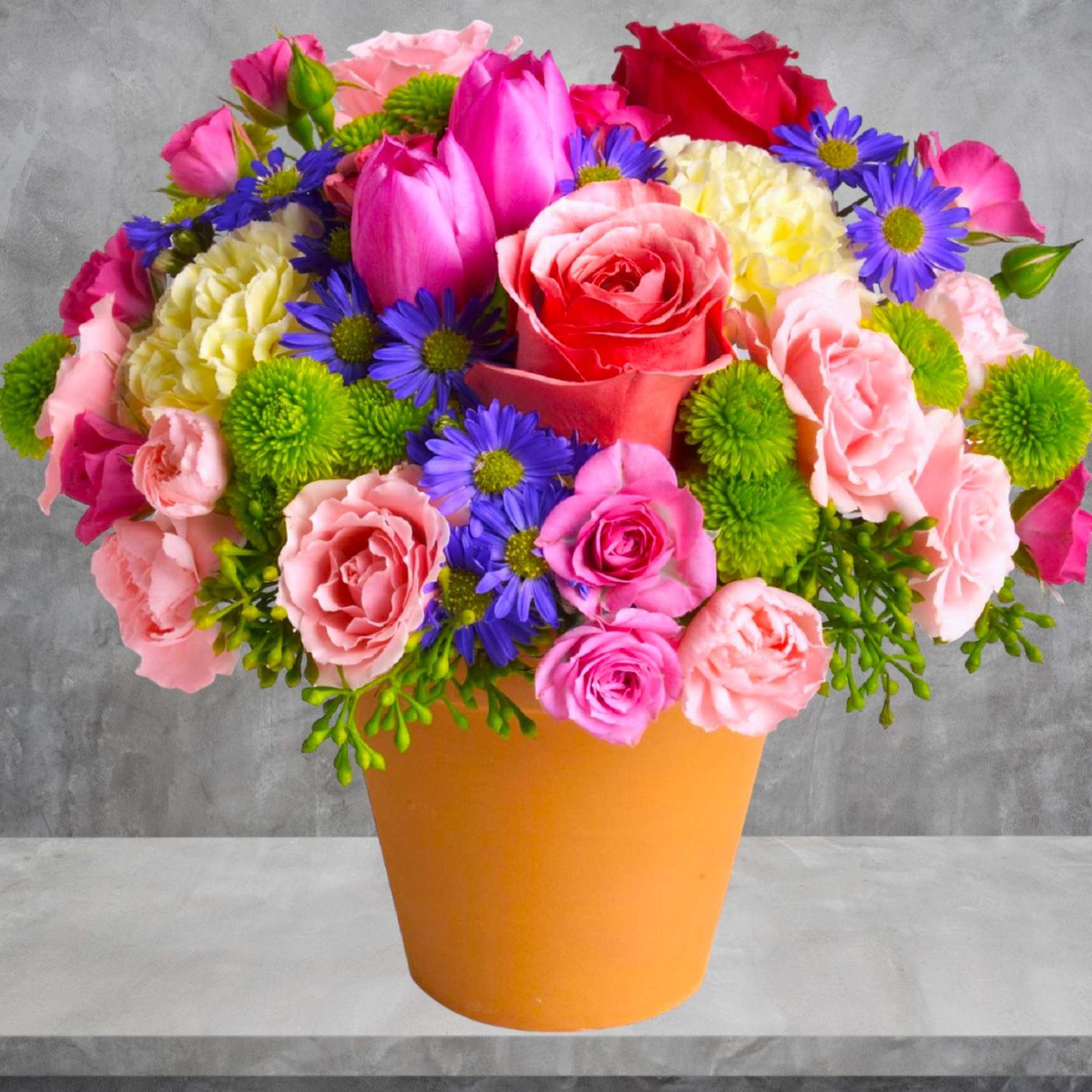 A warm terra-cotta pot and lots of fun colors give this arrangement
