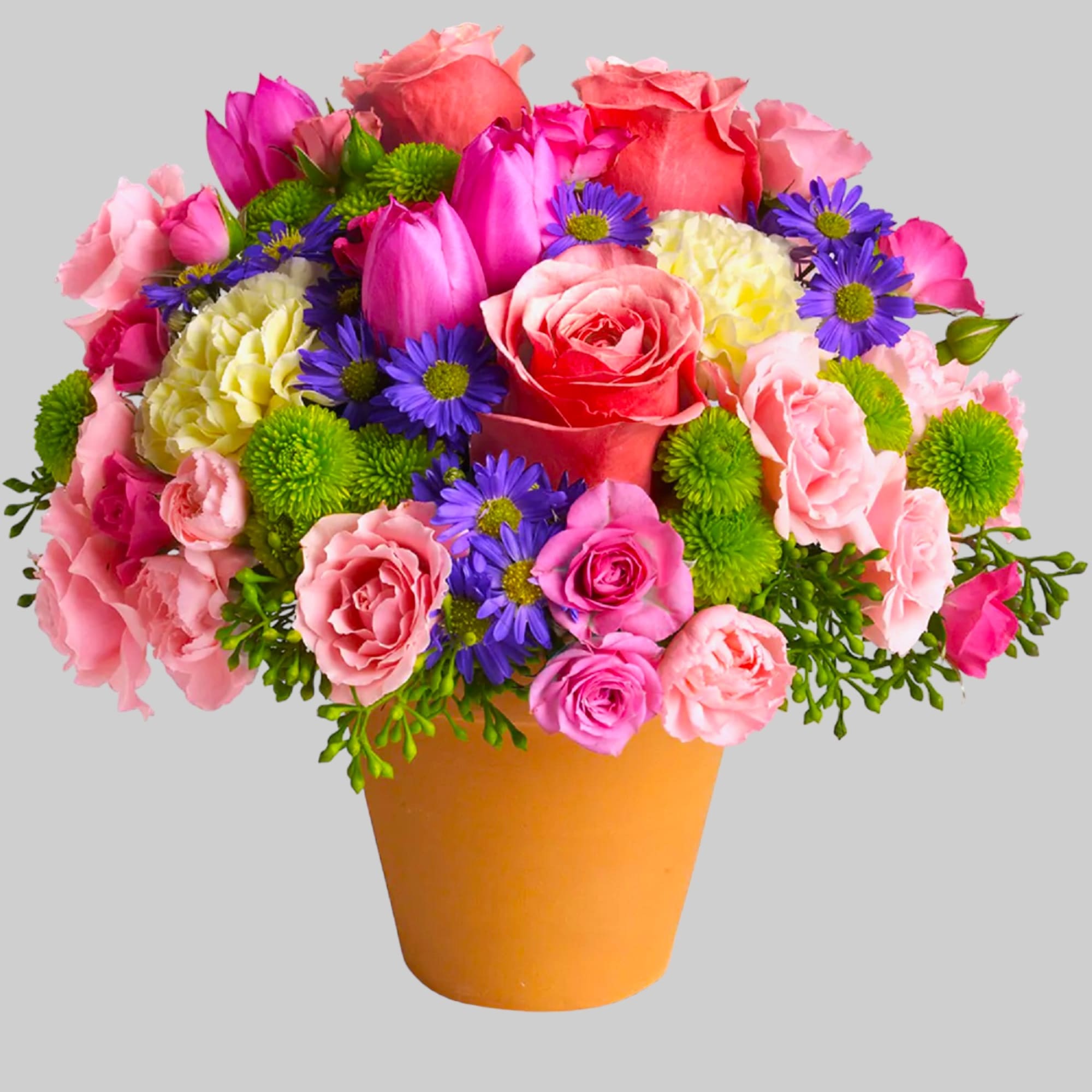 A warm terra-cotta pot and lots of fun colors give this arrangement