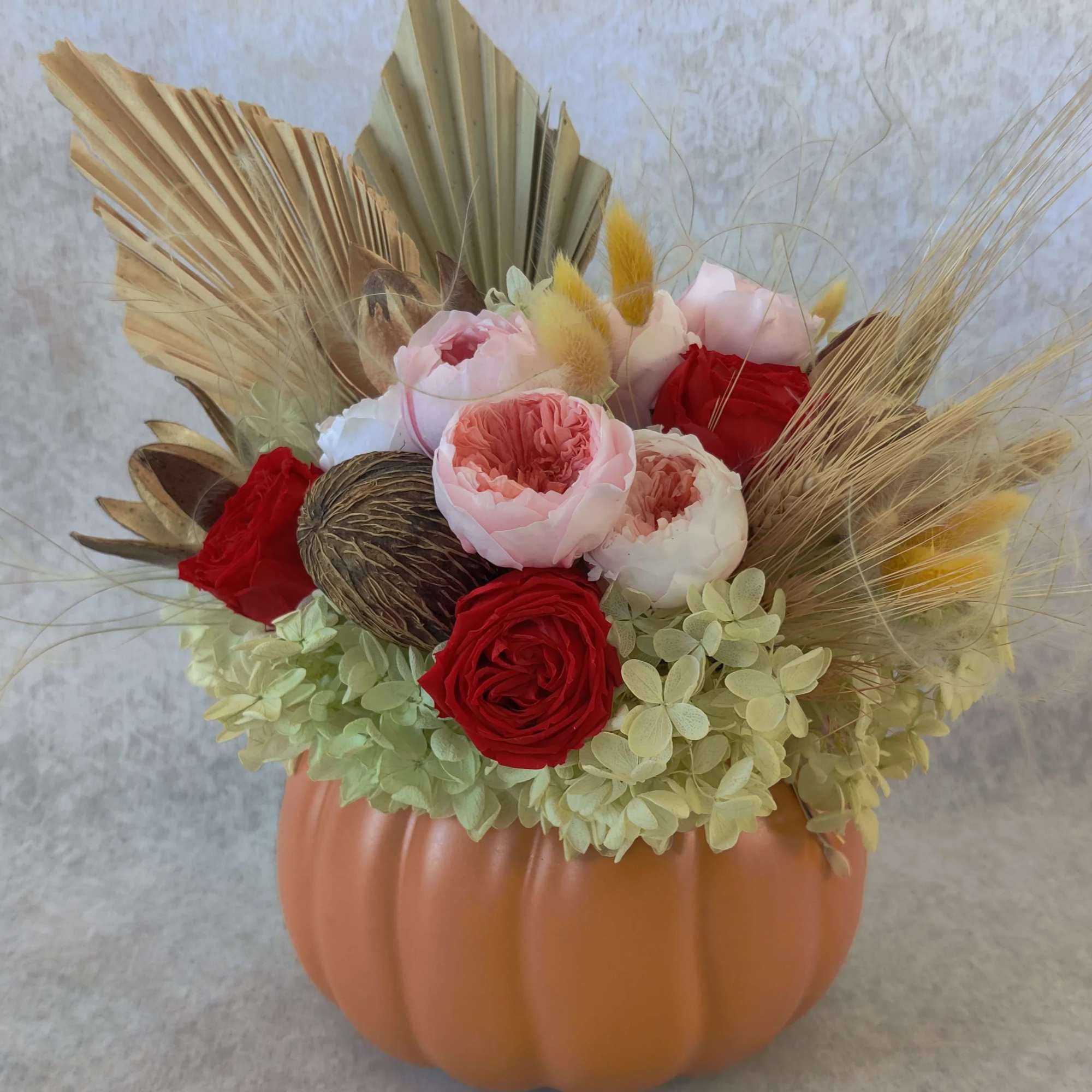 Ceramic pumpkin beautifully arranged with all preserved accents, hydrangeas and garden roses. Ceramic pumpkin beautifully arranged with all preserved accents, hydrangeas and garden roses.