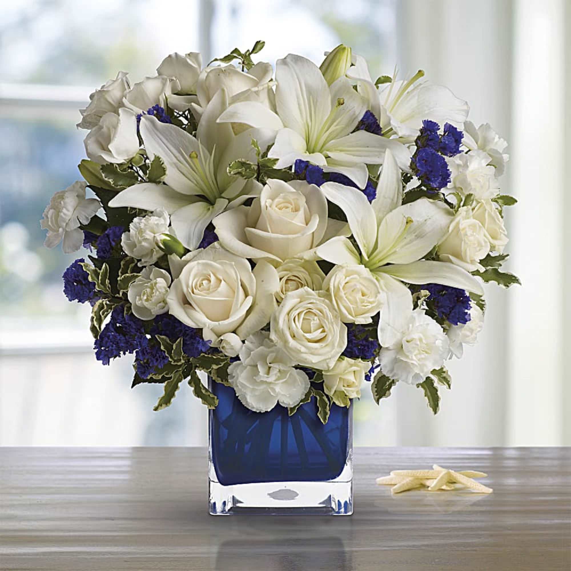 Like gazing into a clear blue sky, this serene arrangement soothes the