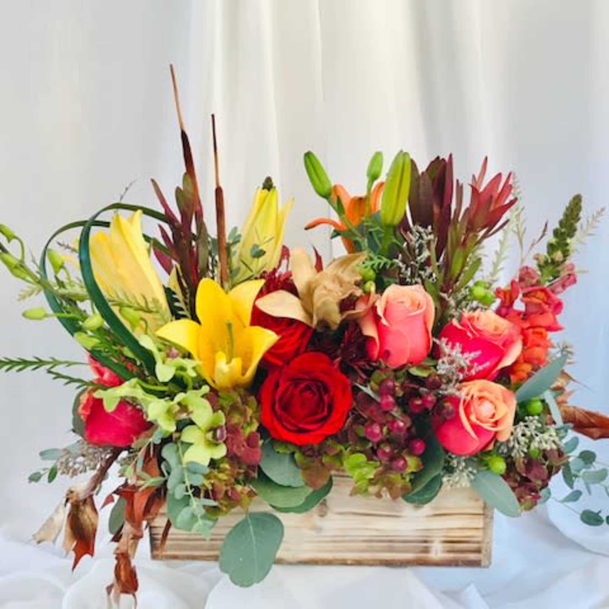 This beautiful assortment of flowers is perfect for the holidays. Give your
