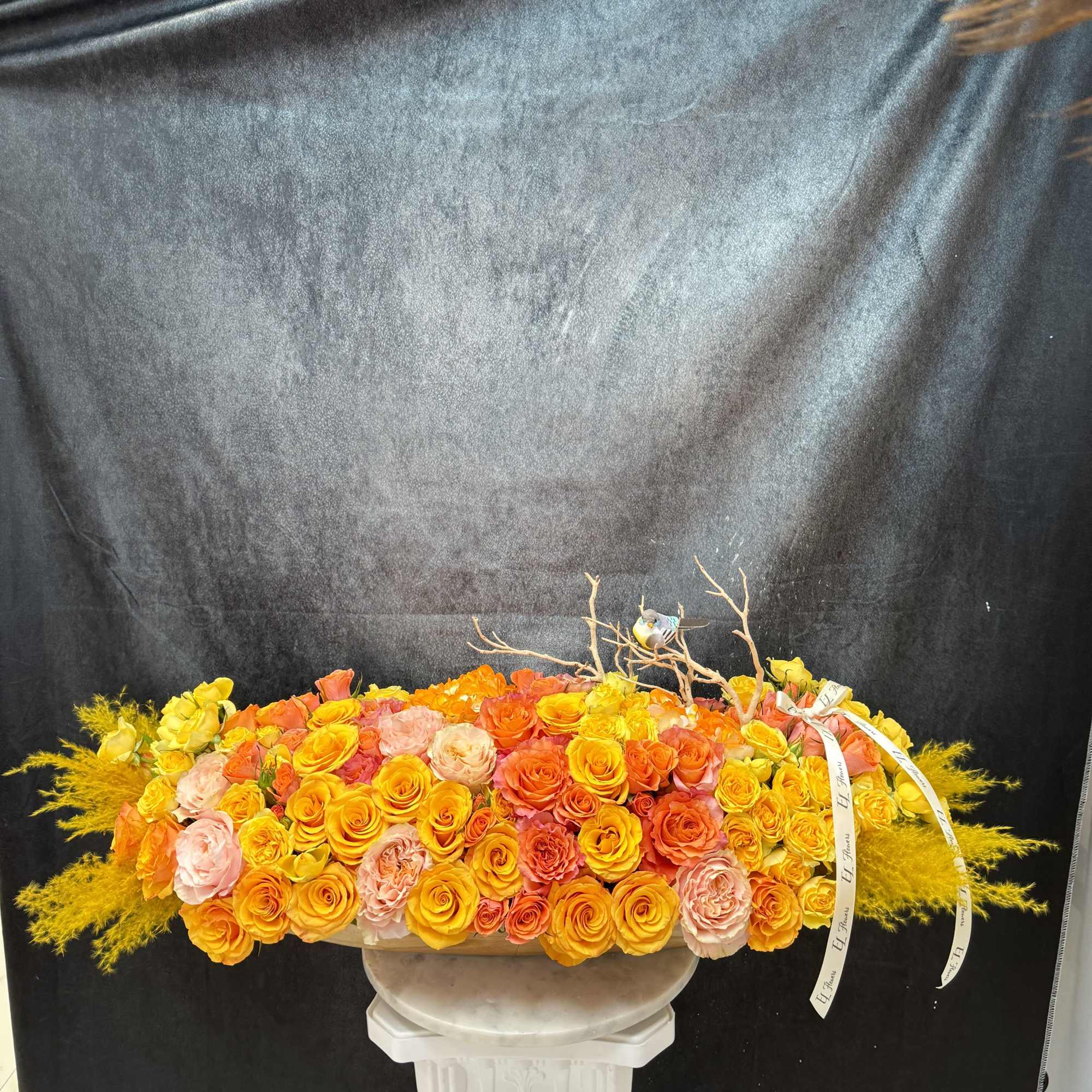 Long arrangement with happy colors and bird