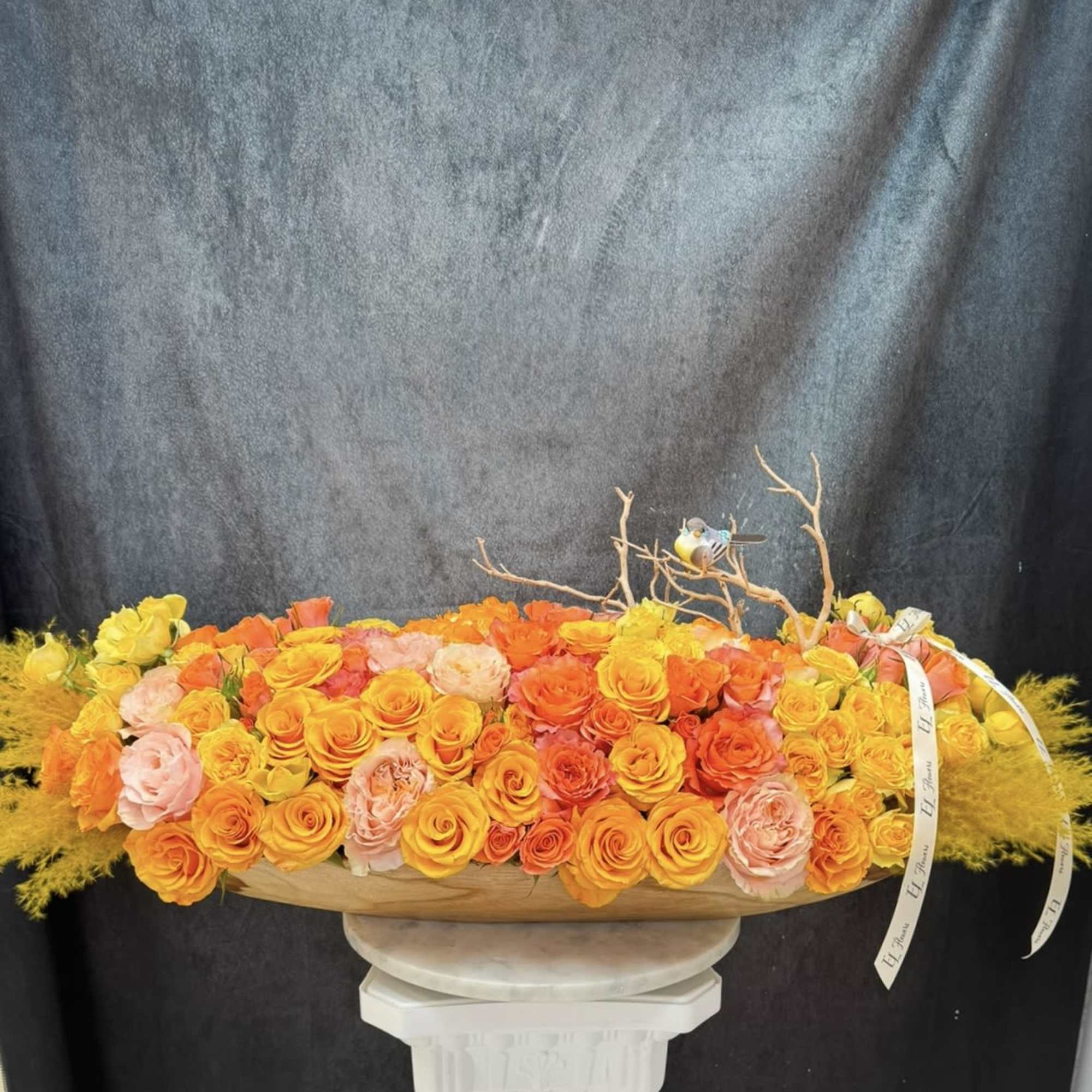 Long arrangement with happy colors and bird