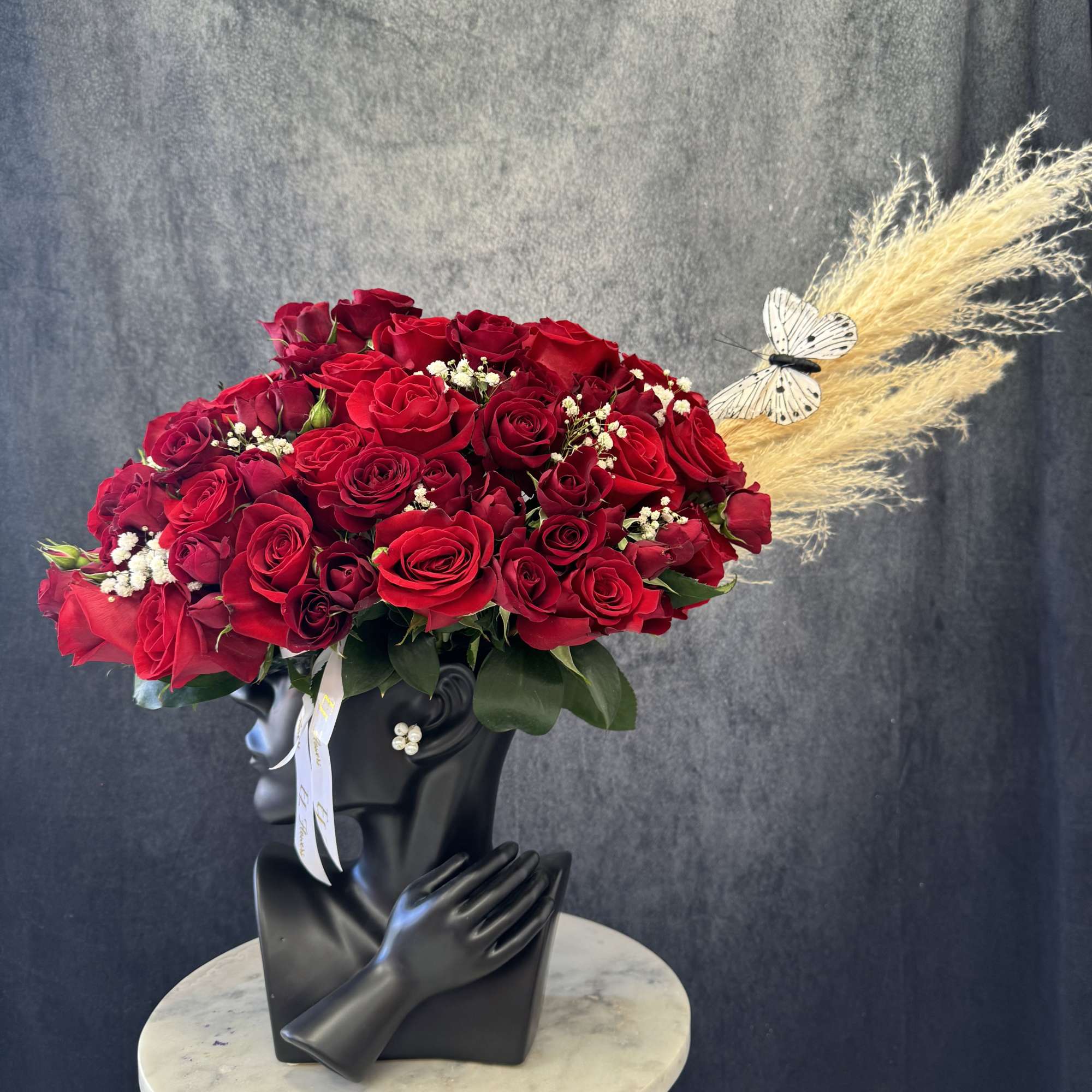 Gorgeous arrangement with glamour vase and red roses