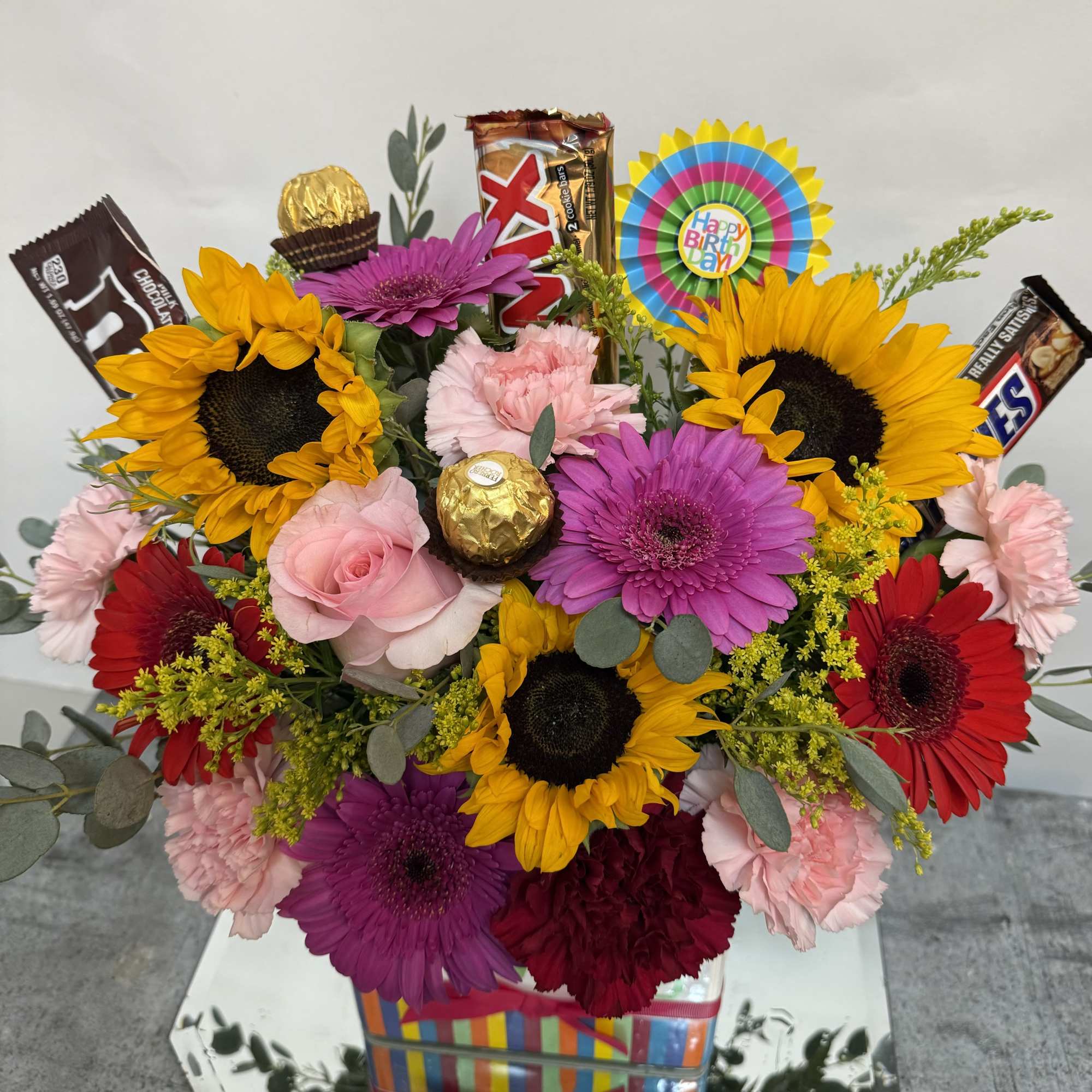 Birthday flowers with chocolate candies 