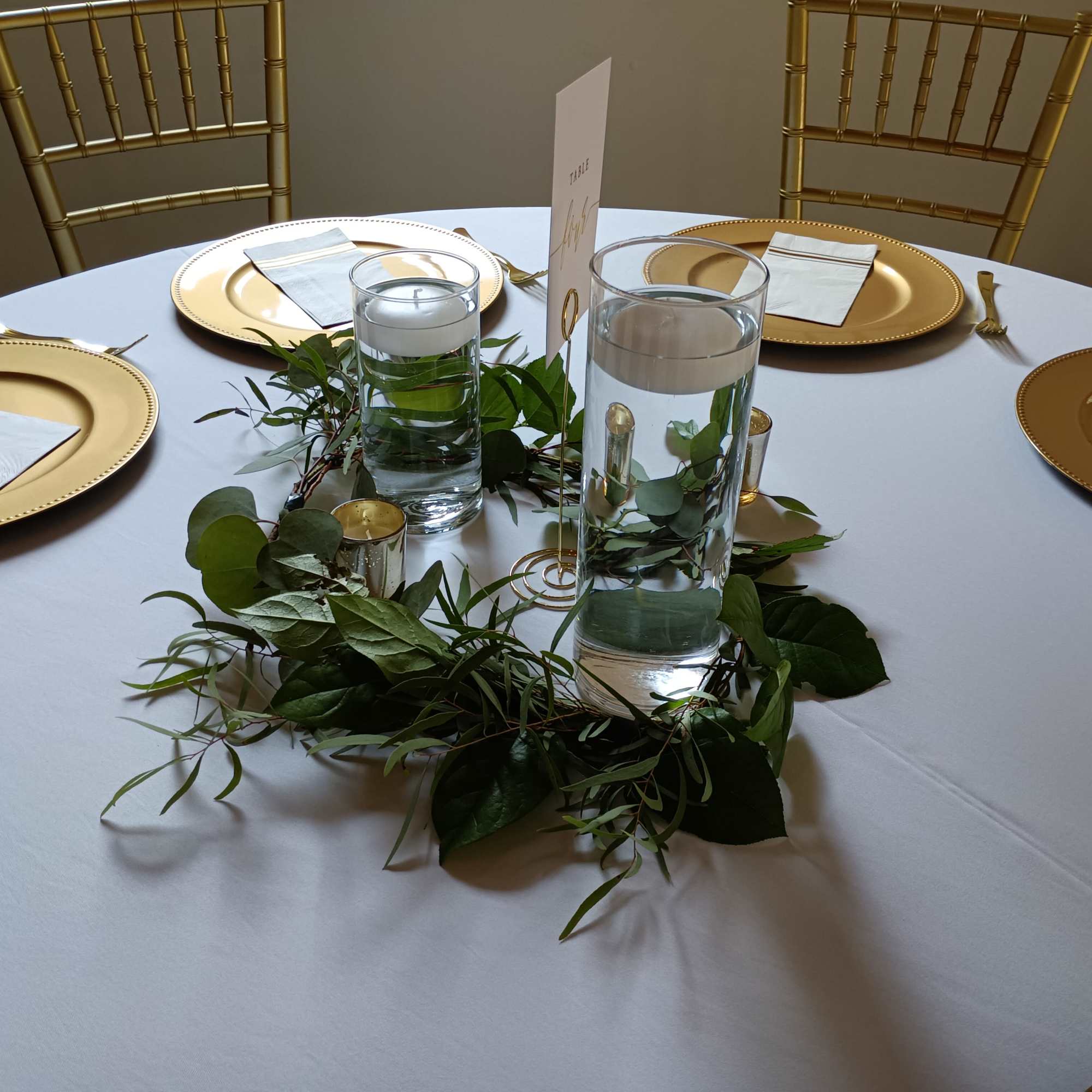 Popular reception table  decor - mixed greens wreath (babies breath and