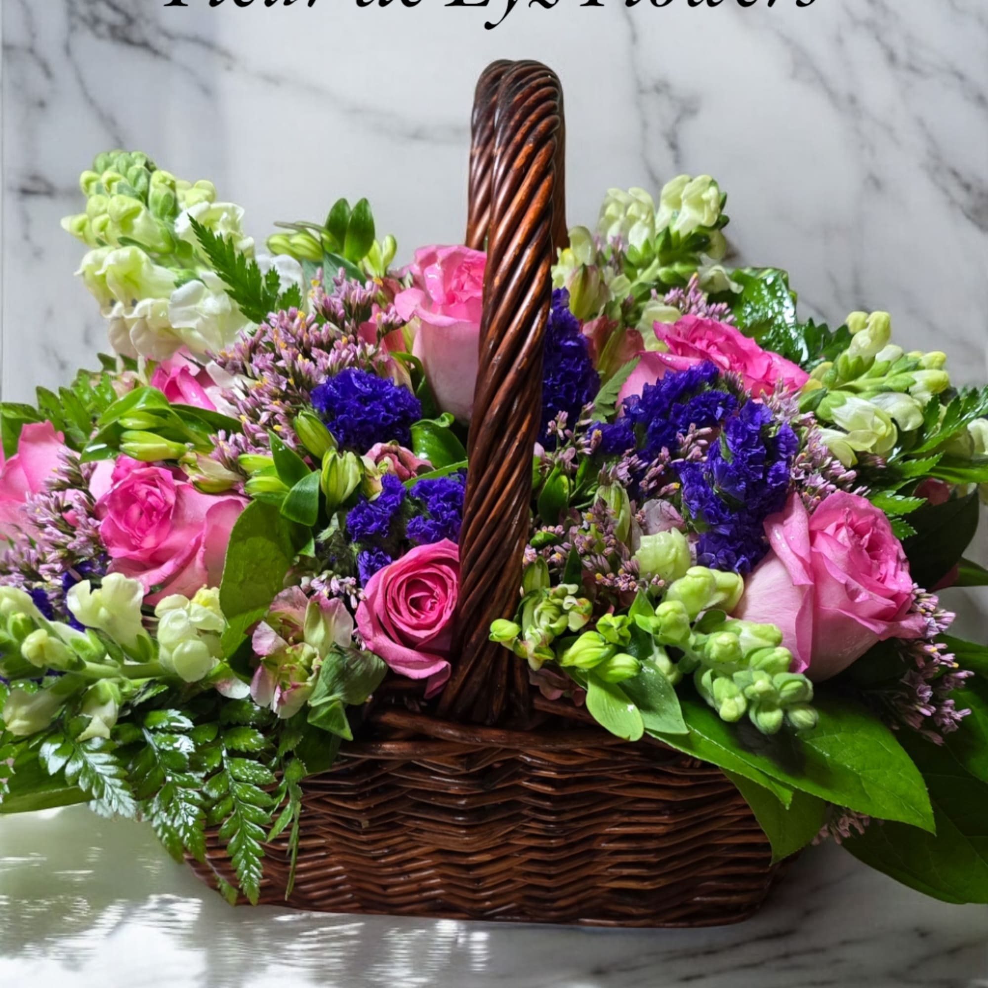 A lovely basket bouquet which includes pin roses and whiesnap dragons.