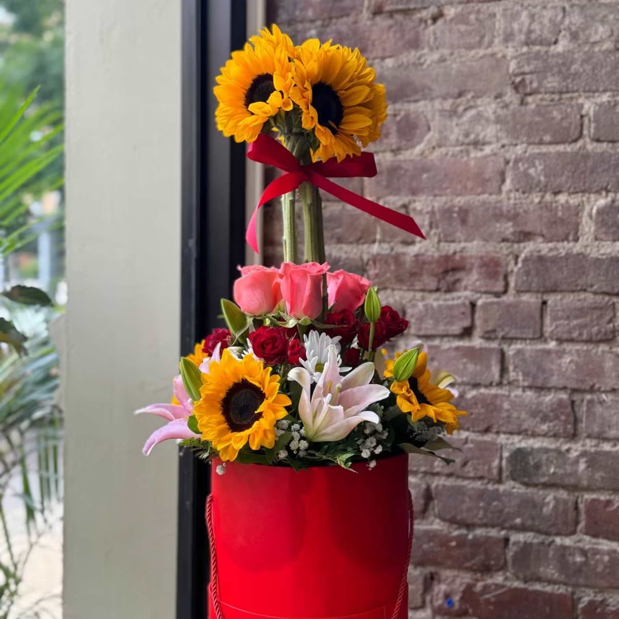 Sunflower arrangement with lilies for any occasion.