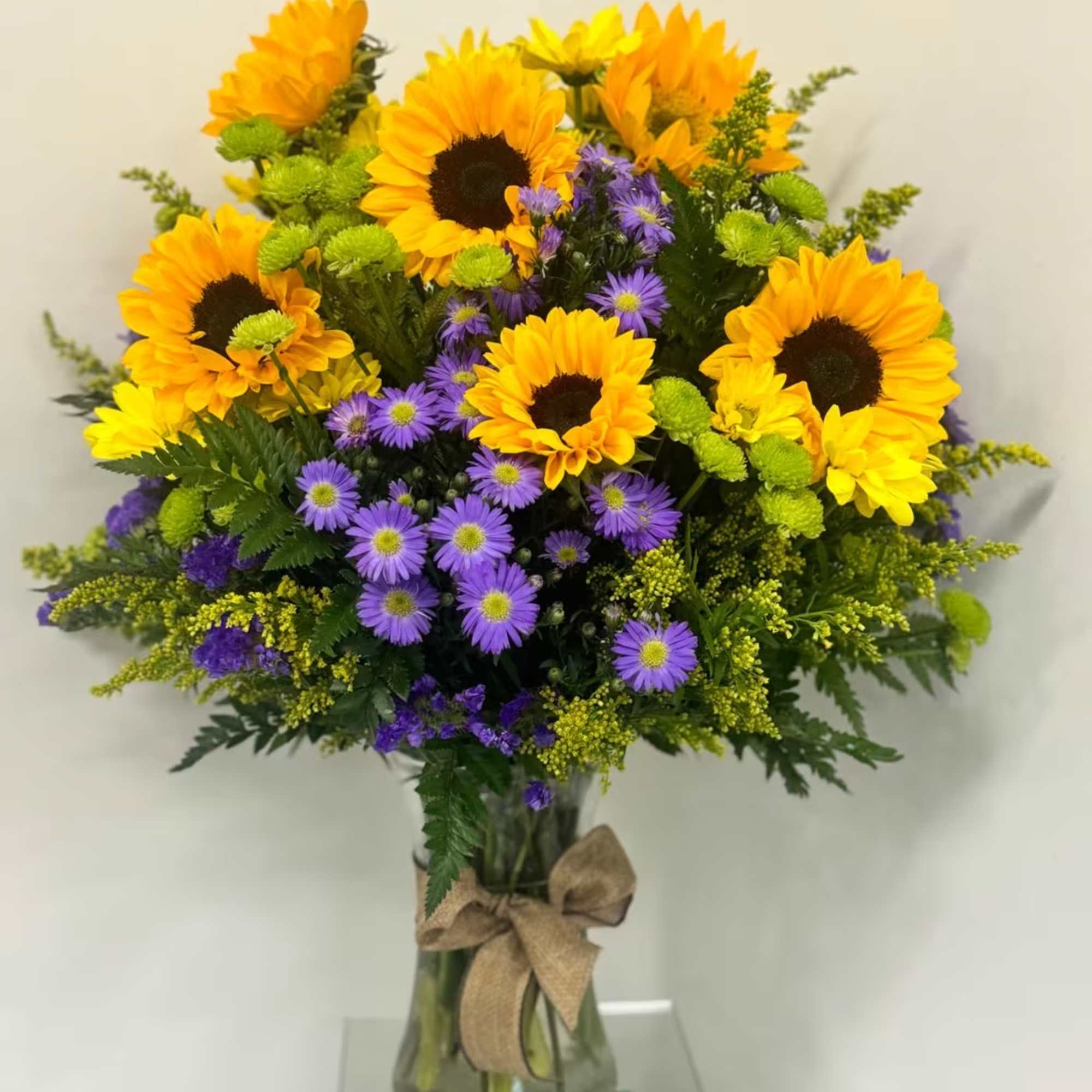 Sunflowers arrangement, it has 8 sunflowers with some greenery. Beautiful Sunflower arrangement