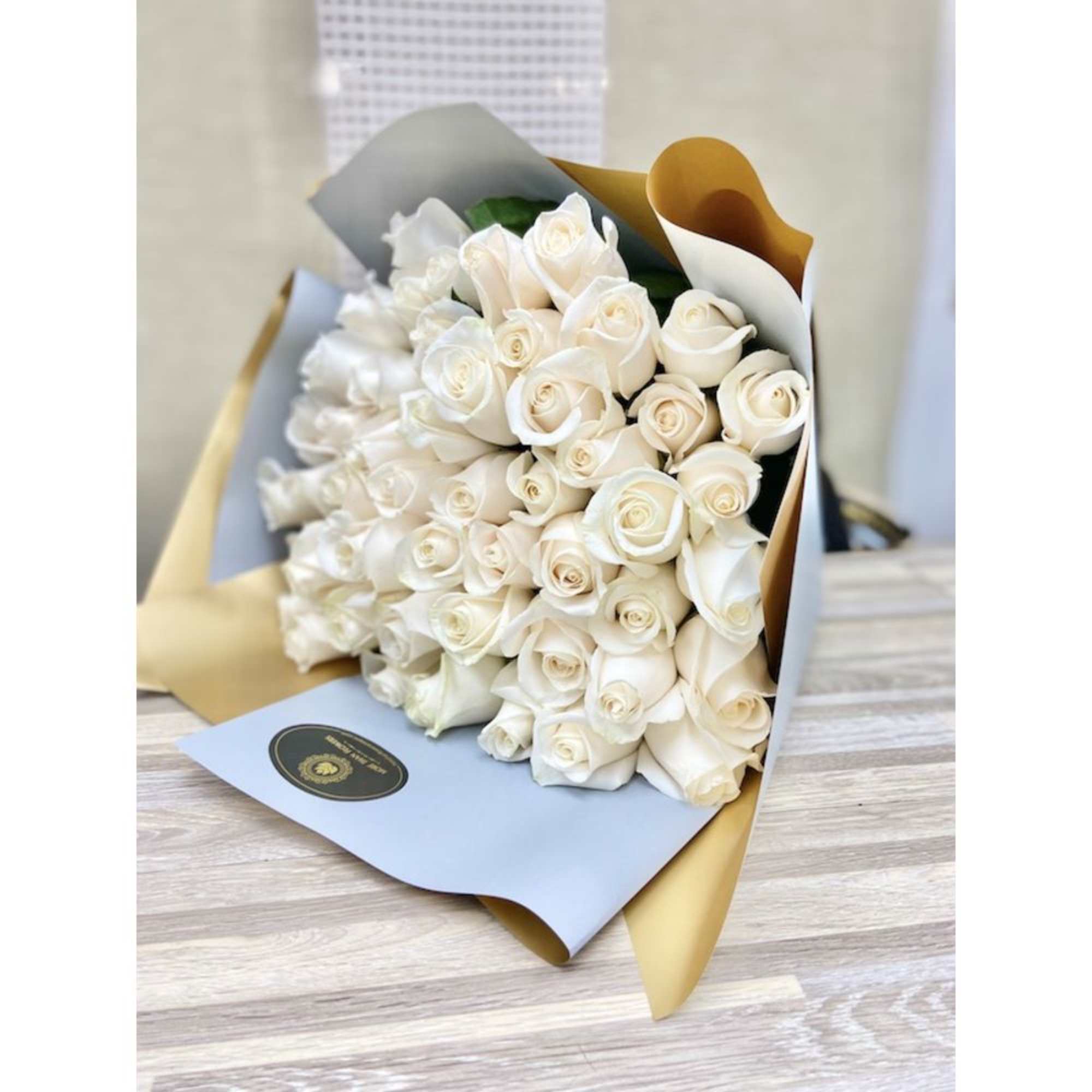 50 Roses Handheld Round Bouquet: Artistically wrapped in our special Euro Floral