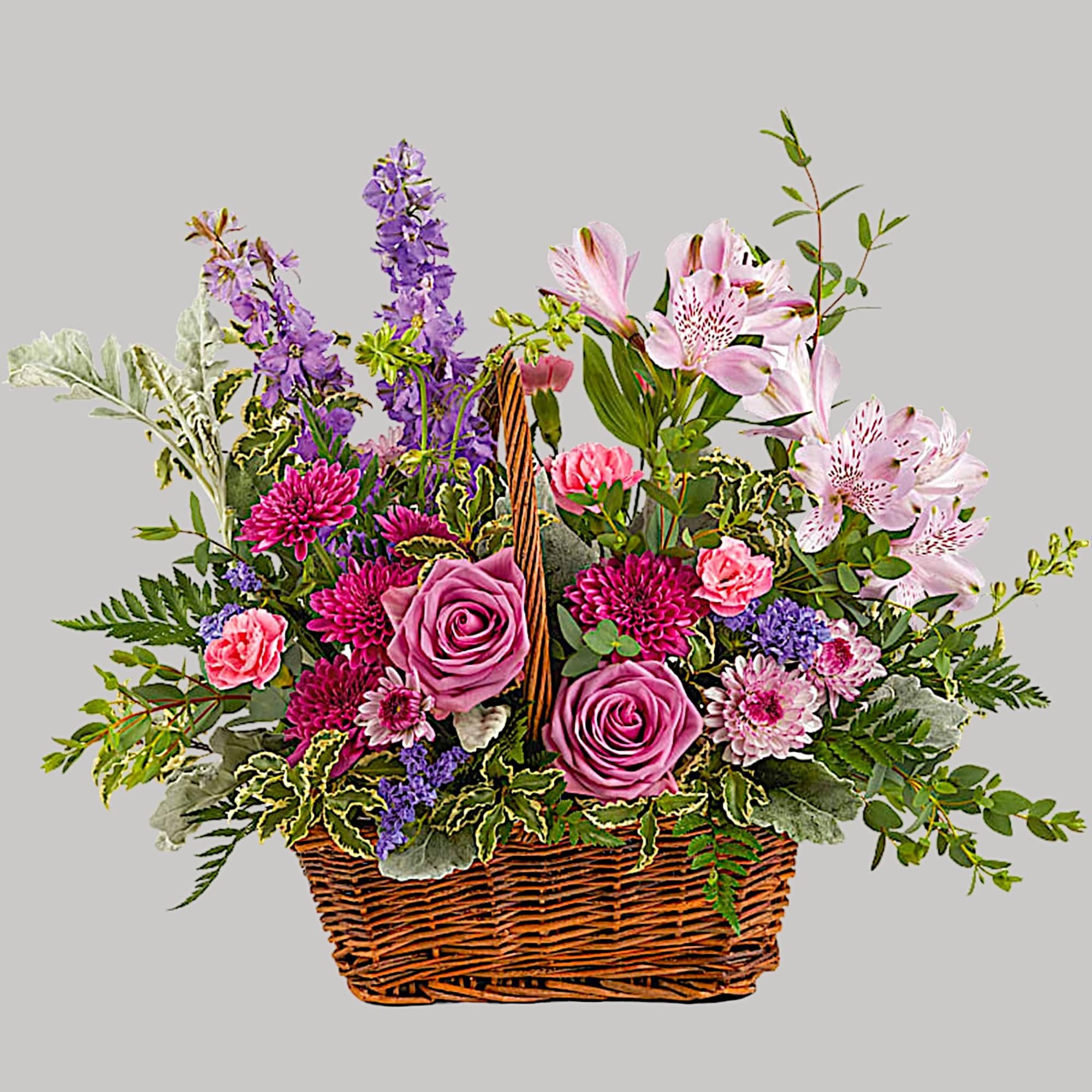 This lush lavender rose arrangement is a basket of beauty to brighten