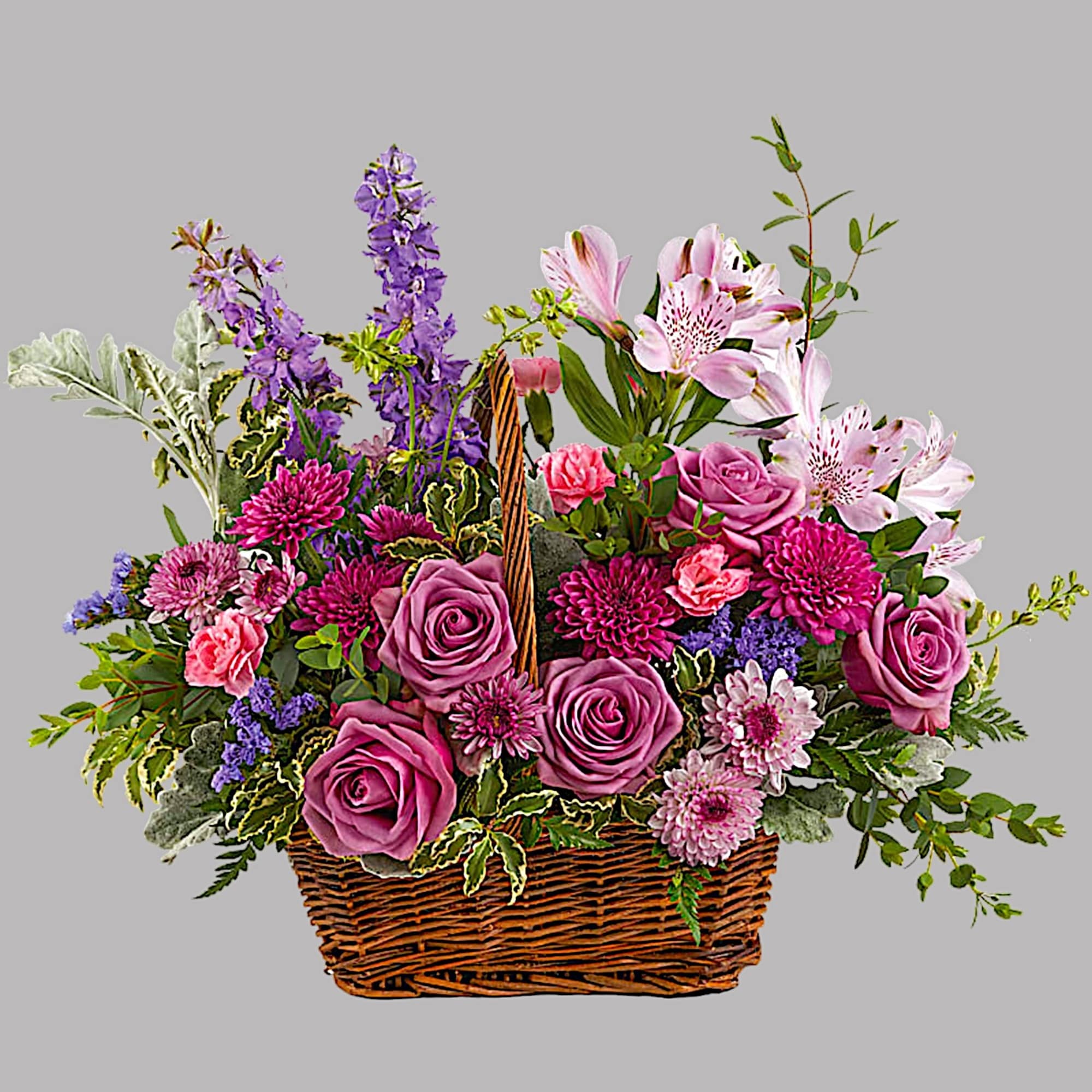 This lush lavender rose arrangement is a basket of beauty to brighten