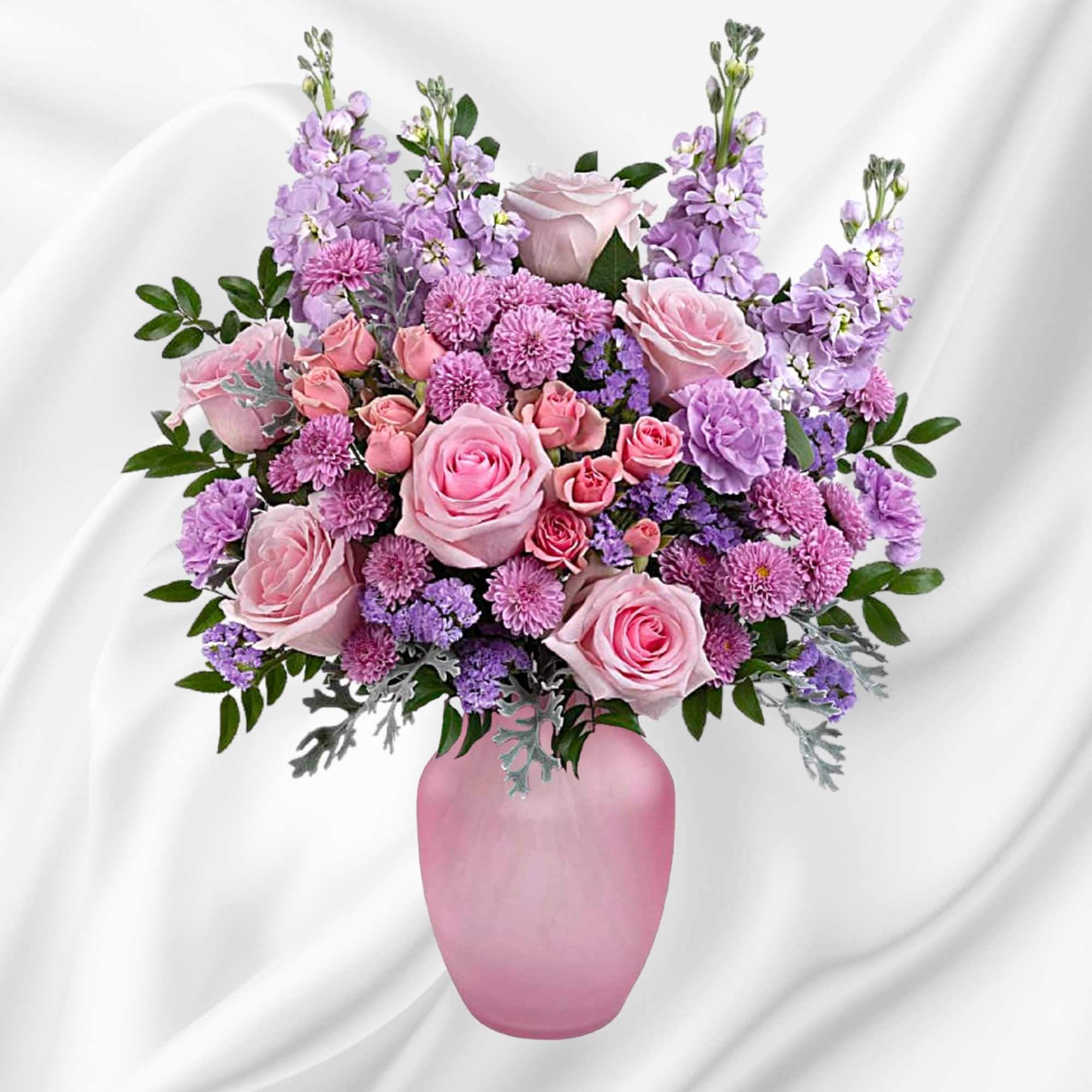What a delight! Overflowing with pink roses and lavender blooms, this decadent