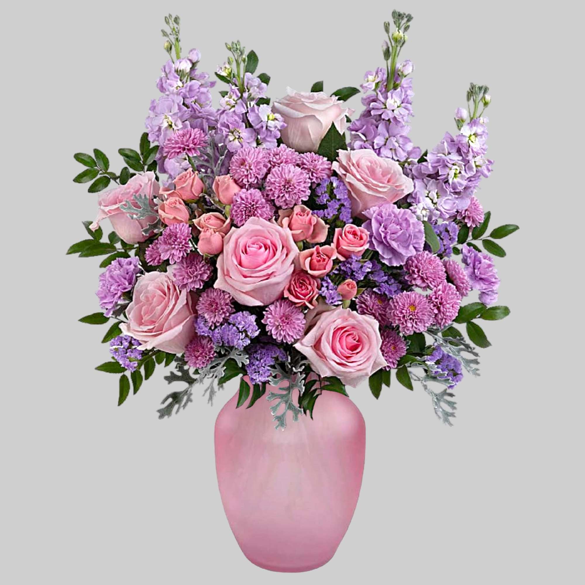 What a delight! Overflowing with pink roses and lavender blooms, this decadent