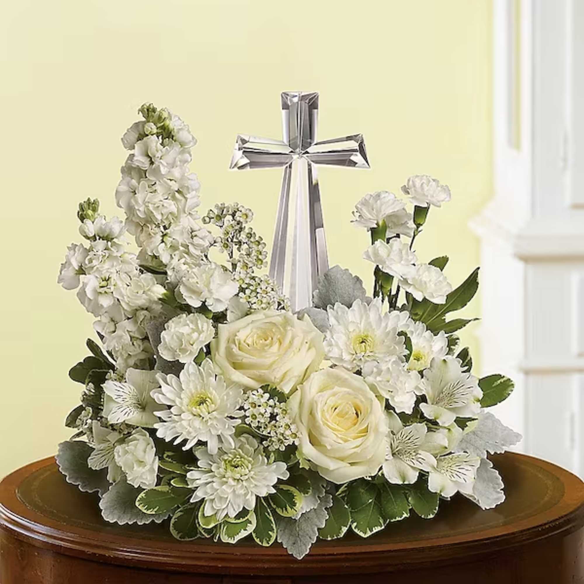 An elegant display of faith and divine peace, this beautiful arrangement will