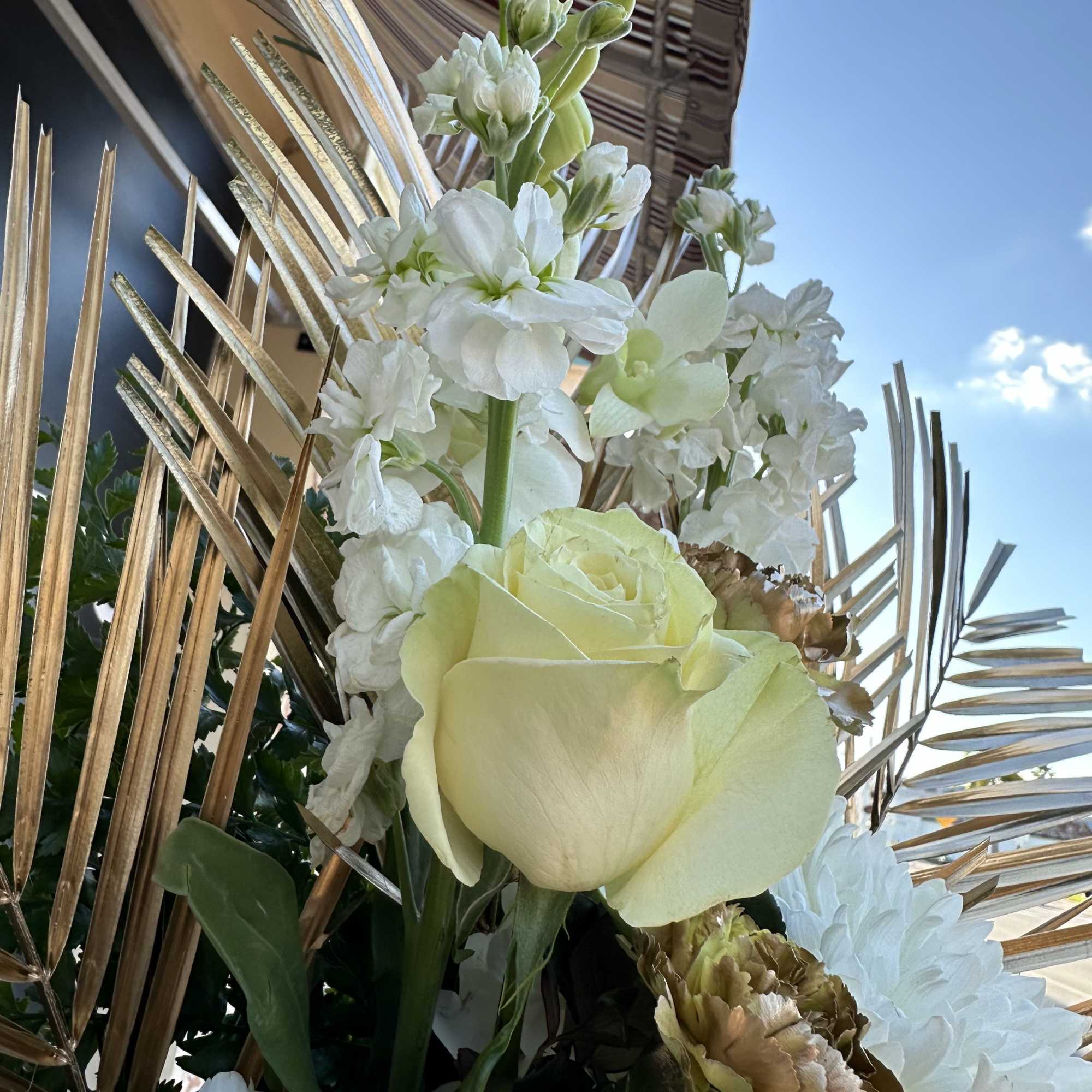 Express your sympathy with GOLD and WHITE. A very unique standing spray!