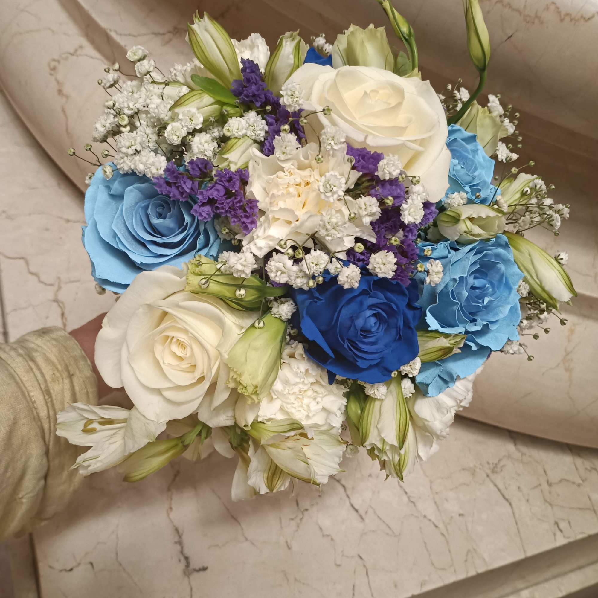 Beautiful unusual light and dark blue roses, white roses, alstroemeria, carnations and