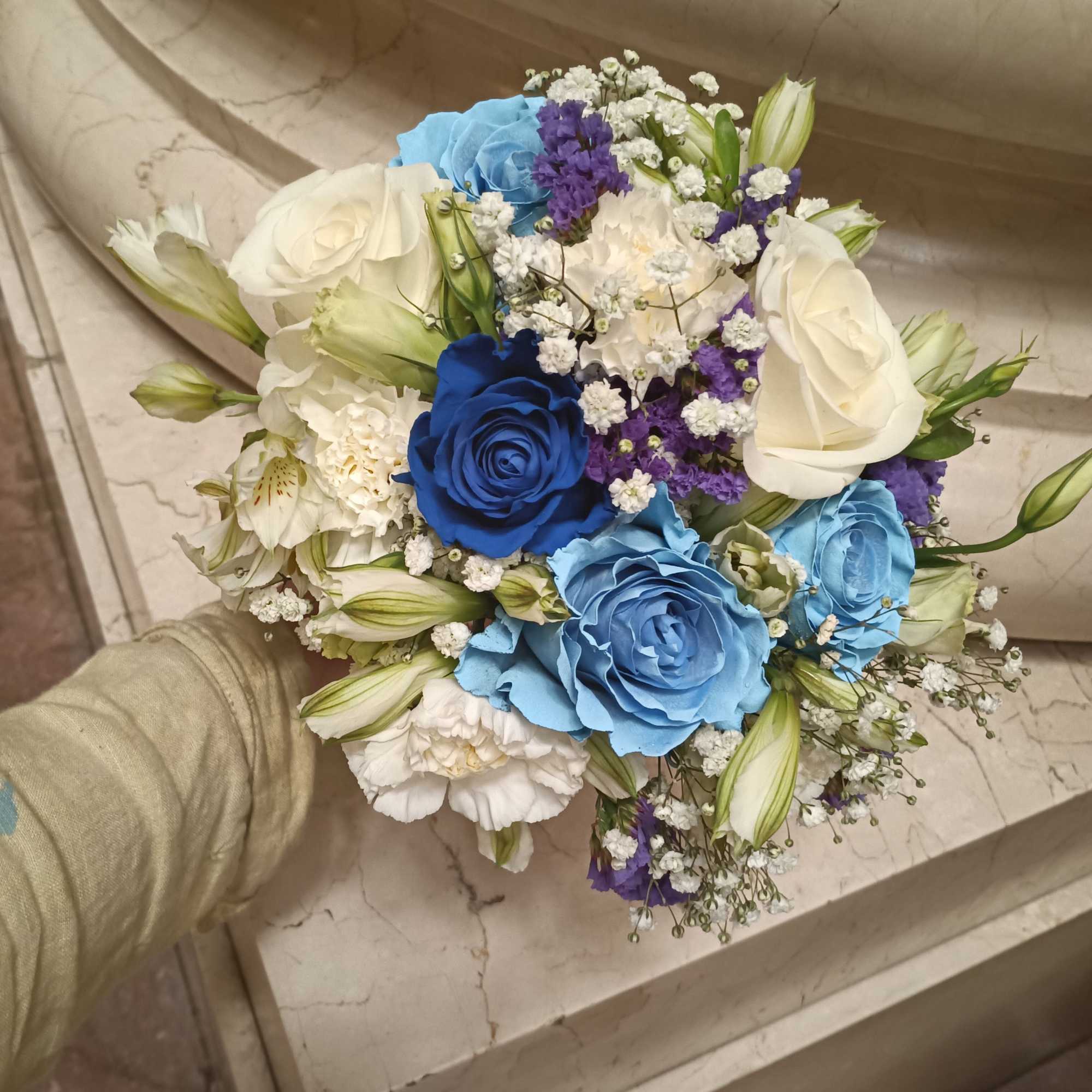 Beautiful unusual light and dark blue roses, white roses, alstroemeria, carnations and
