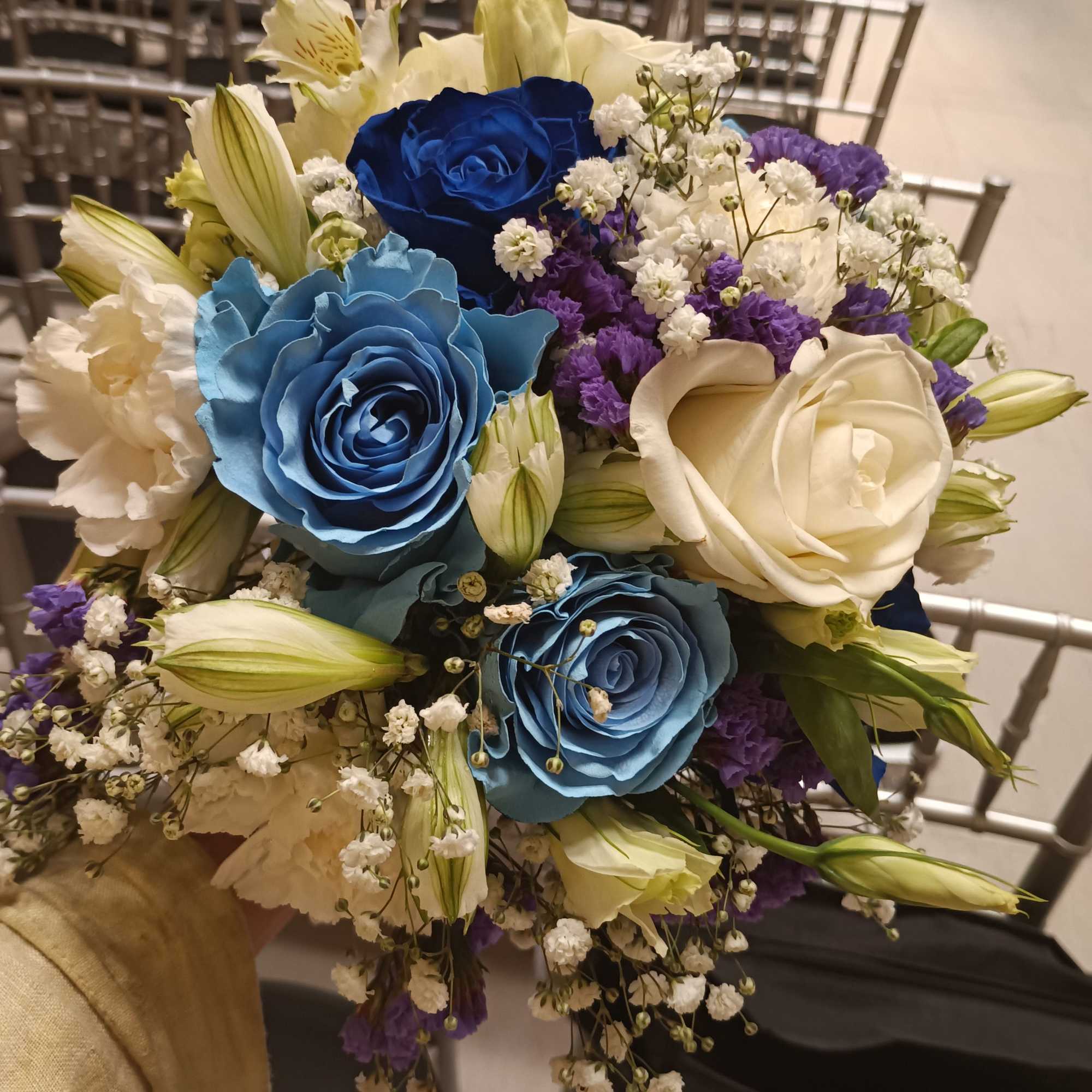 Beautiful unusual light and dark blue roses, white roses, alstroemeria, carnations and