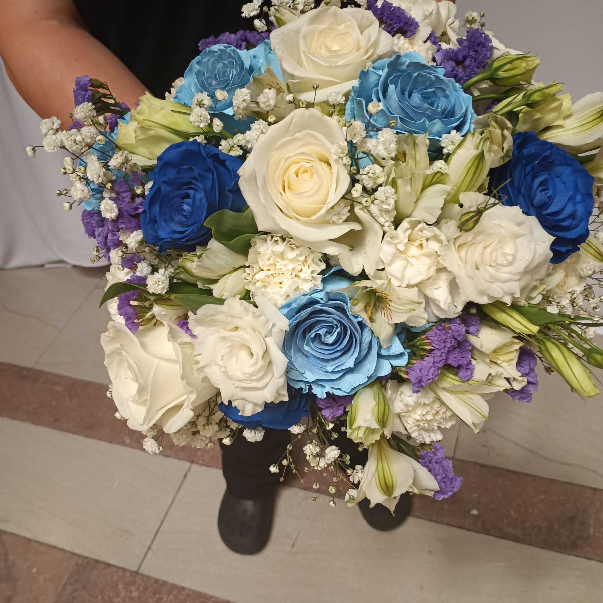 Beautiful unusual light and dark blue roses, white roses, alstroemeria, carnations and