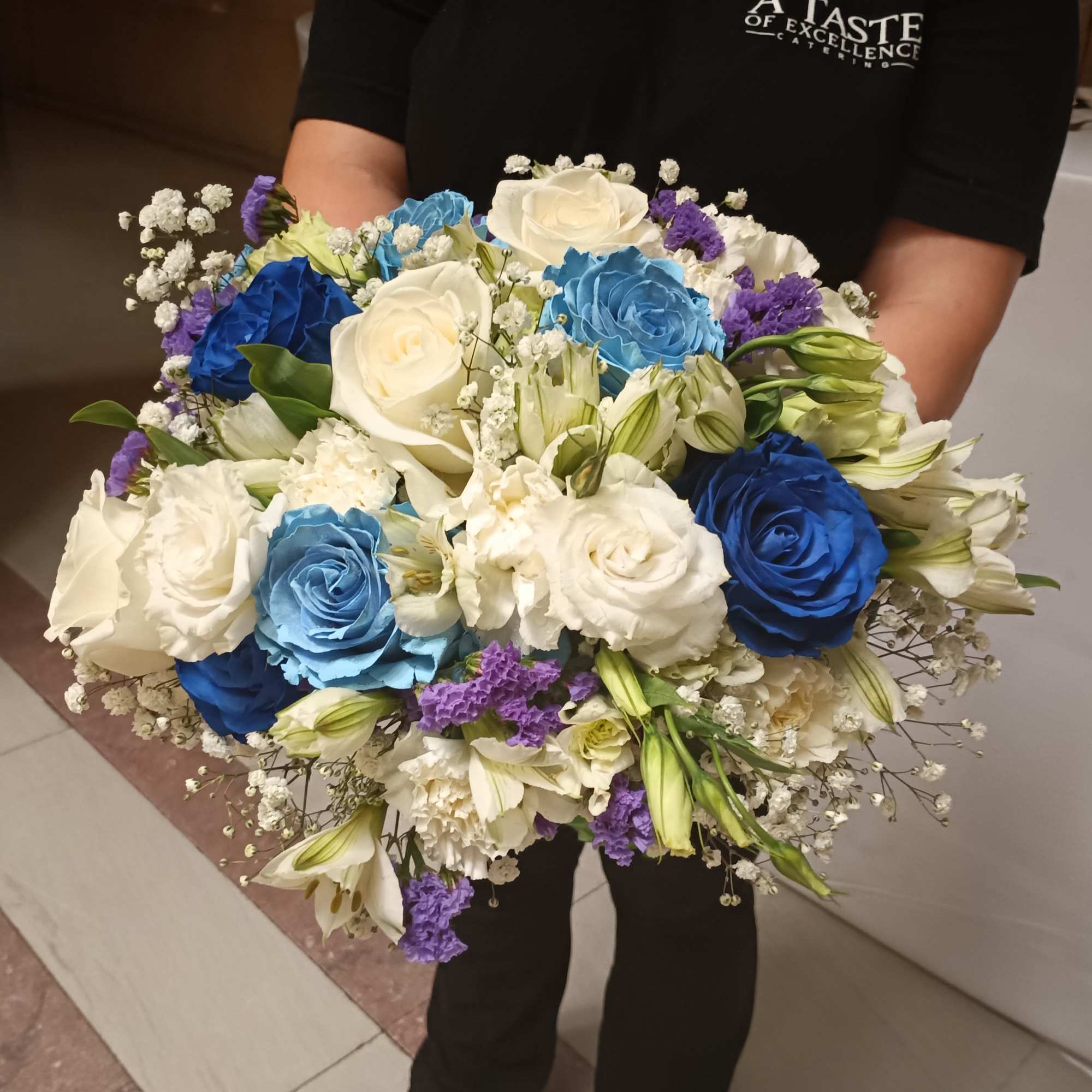 Beautiful unusual light and dark blue roses, white roses, alstroemeria, carnations and