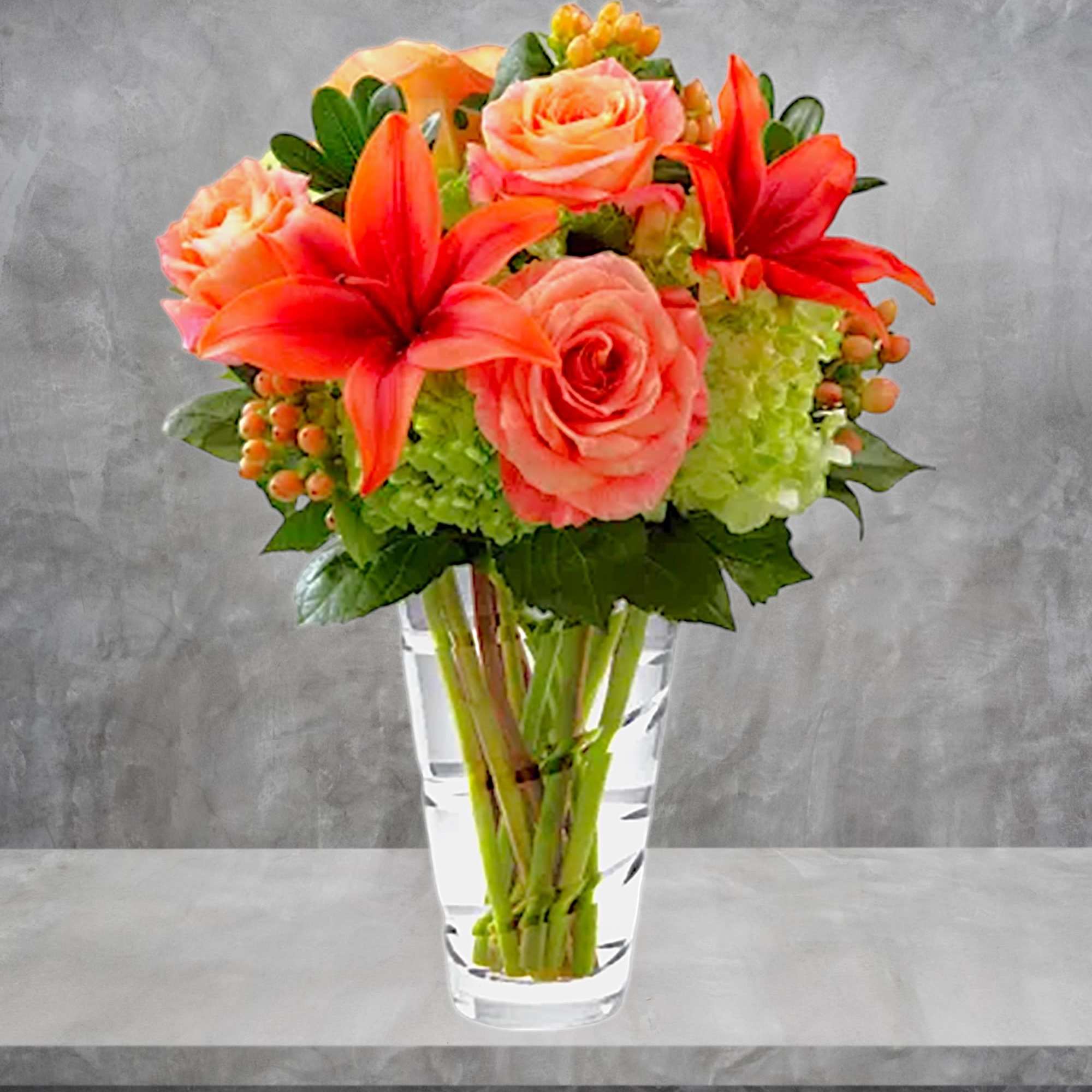 The Vera Wang Dawning Delight Arrangement is an elegant mixture of peach