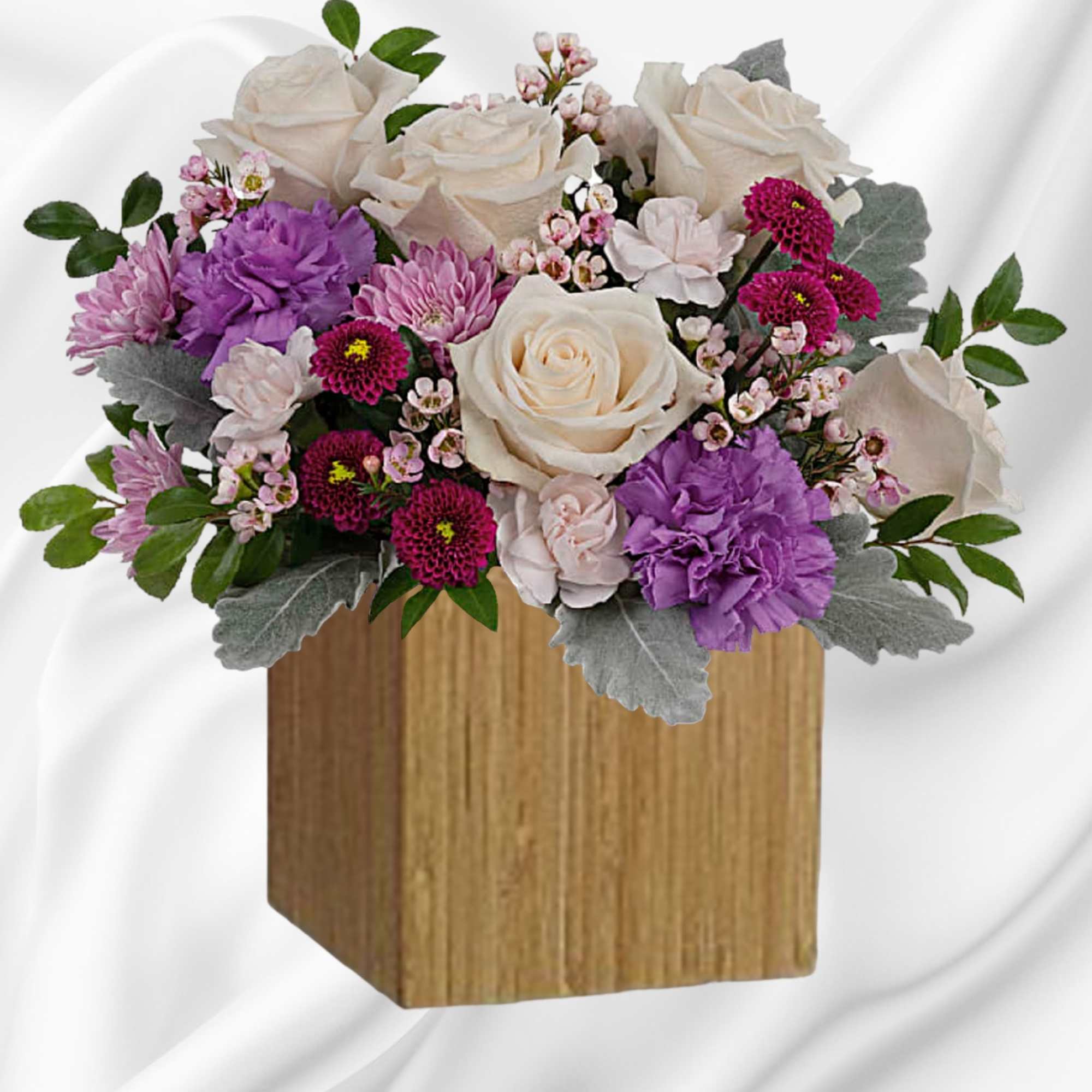 Swirling with flowers this sweet floral arrangement makes a marvelous gift filled