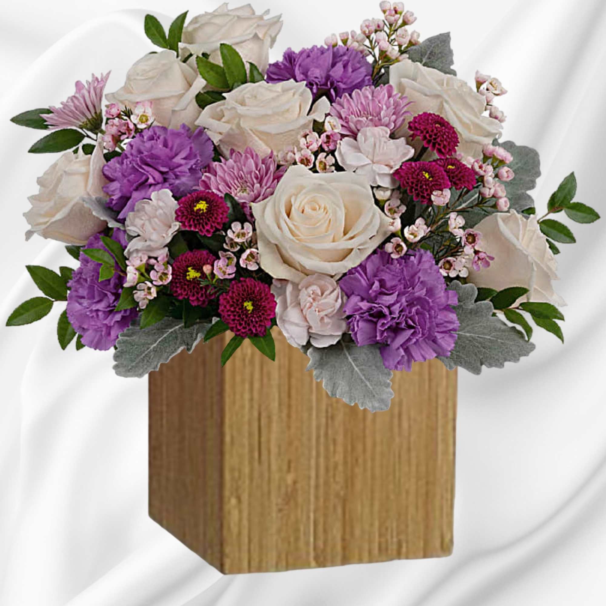 Swirling with flowers this sweet floral arrangement makes a marvelous gift filled