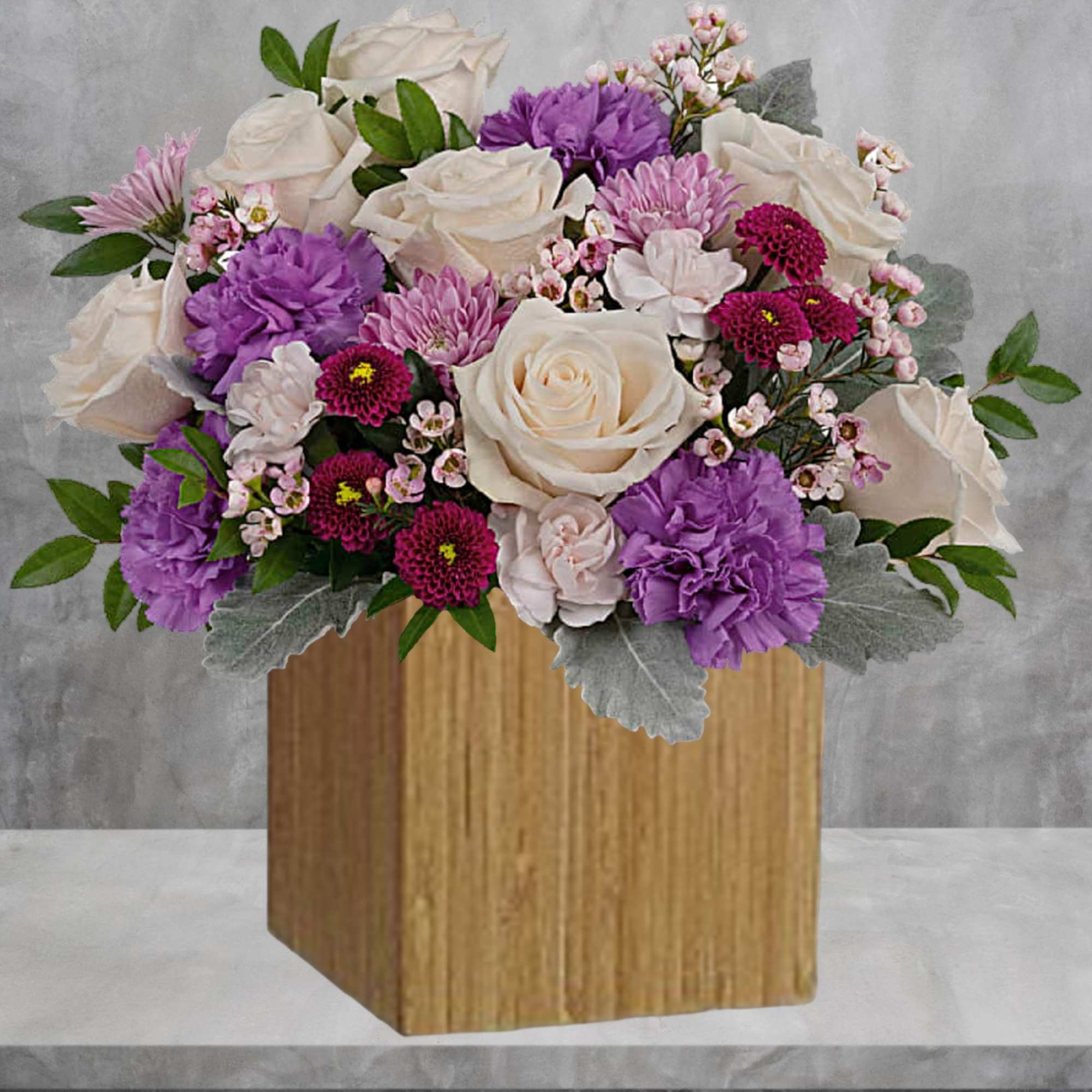 Swirling with flowers this sweet floral arrangement makes a marvelous gift filled