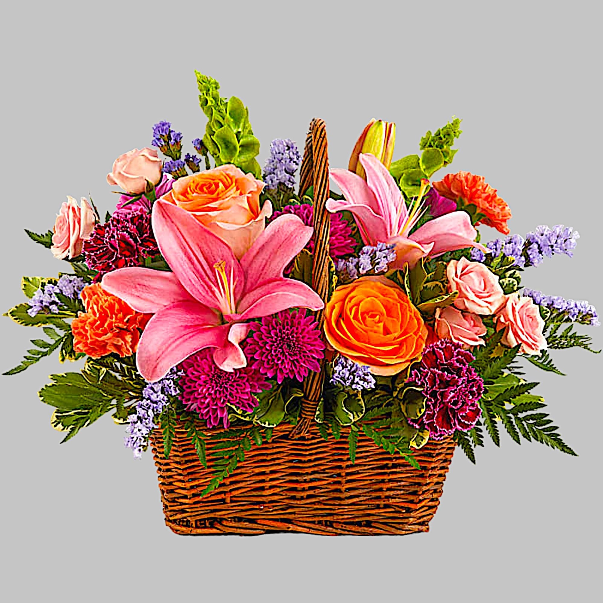 Like an island sunrise, this basket of orange and pink blooms is