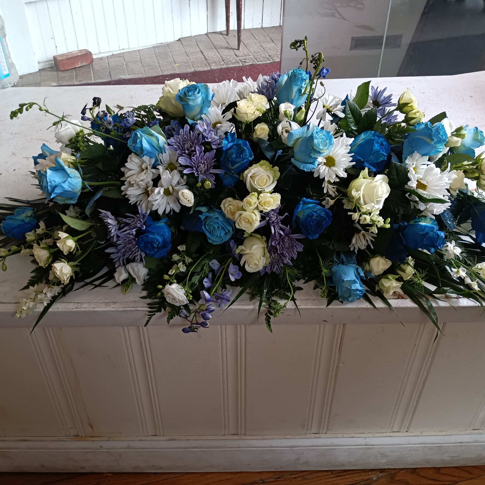 Beautiful deep and light blue and white roses, white daises, carnations, blue